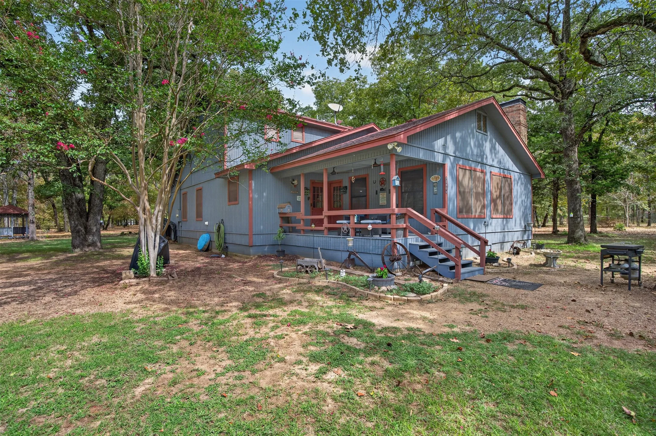 Charming cottage-style home nestled among mature shade trees on expansive grounds