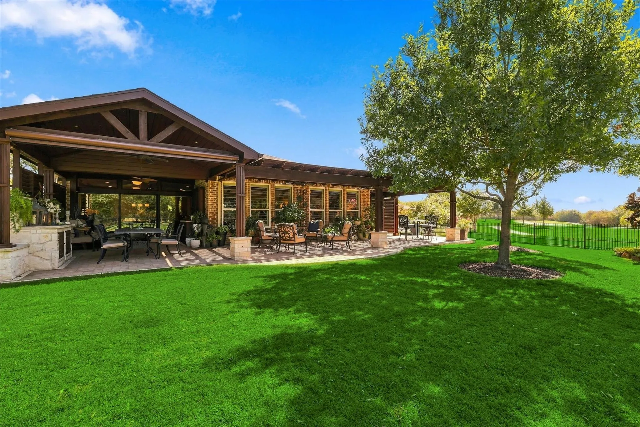 Backyard Oasis great for entertaining with covered patio featuring a vaulted ceiling and built-in elements, and an additional uncovered patio area