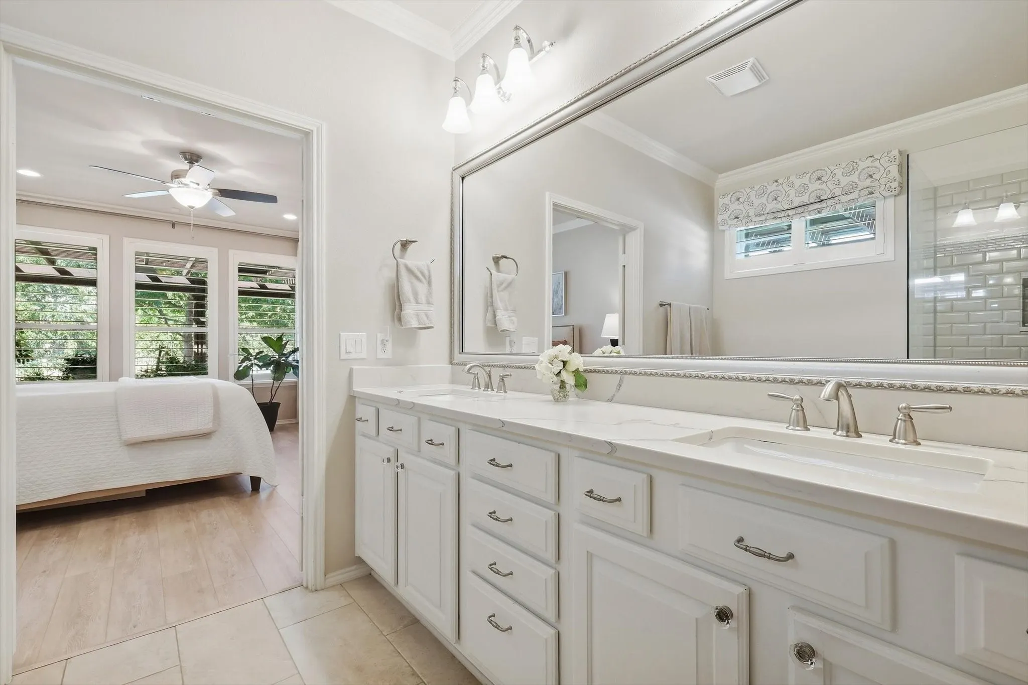 Ensuite Primary Bathroom with a Double vanity, integrated countertop, undermount sinks, and brushed nickel faucets