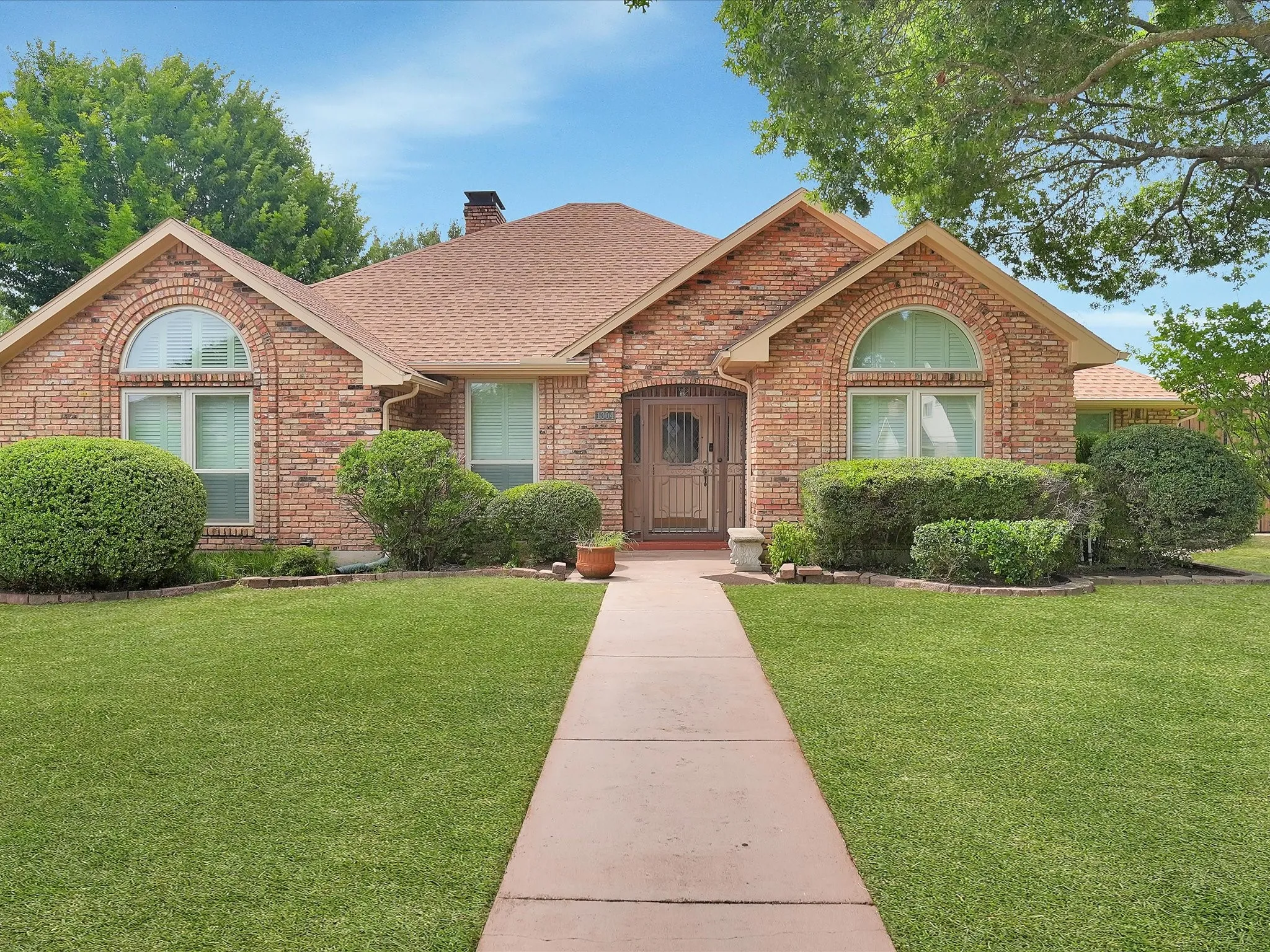 Brick exterior with a gabled roof and arched windows