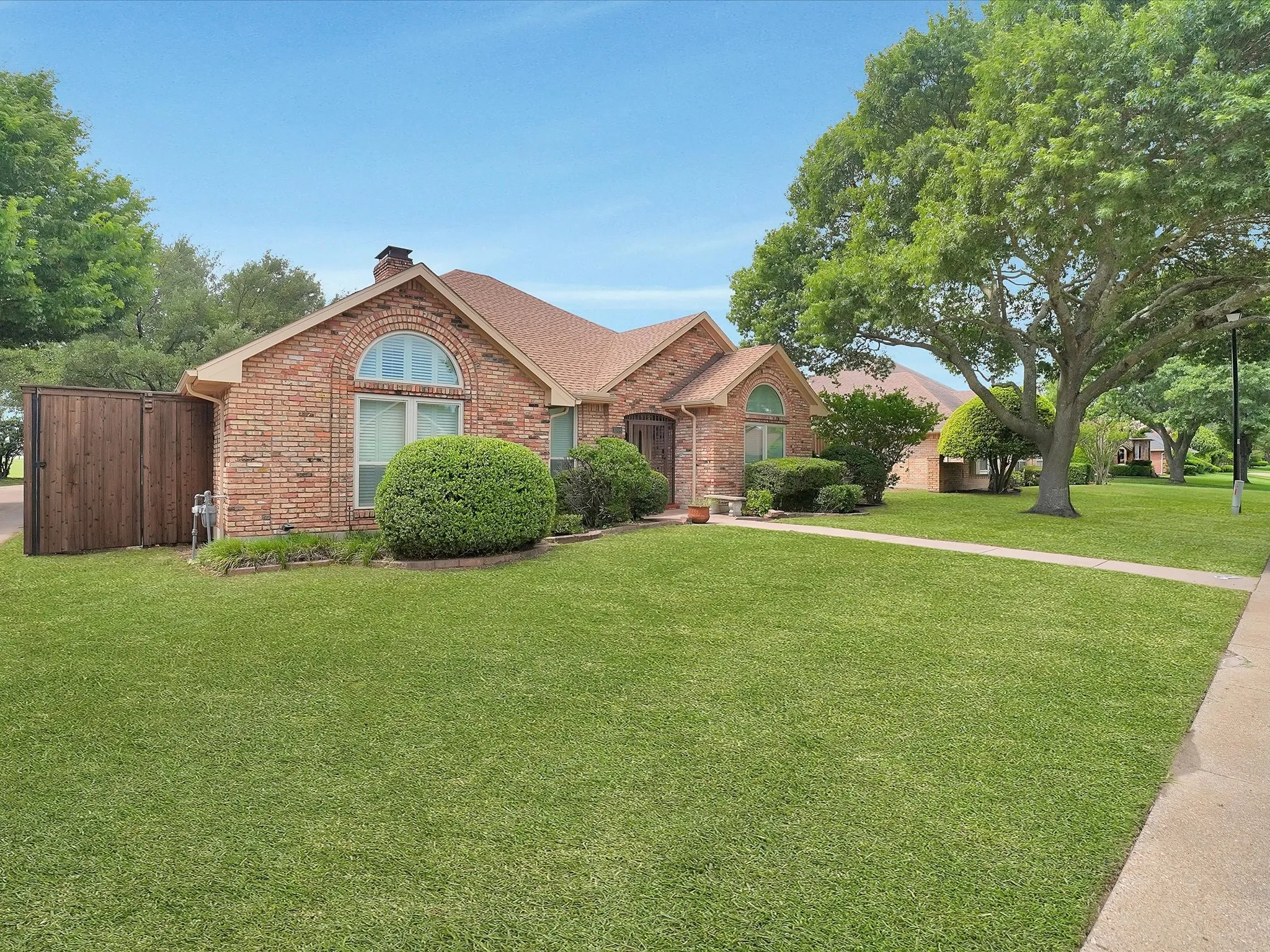 Brick exterior with architectural arch window and a gabled roof