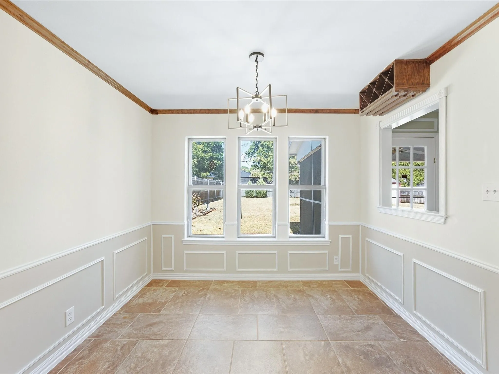 Tiled flooring complementing wainscoting and crown molding