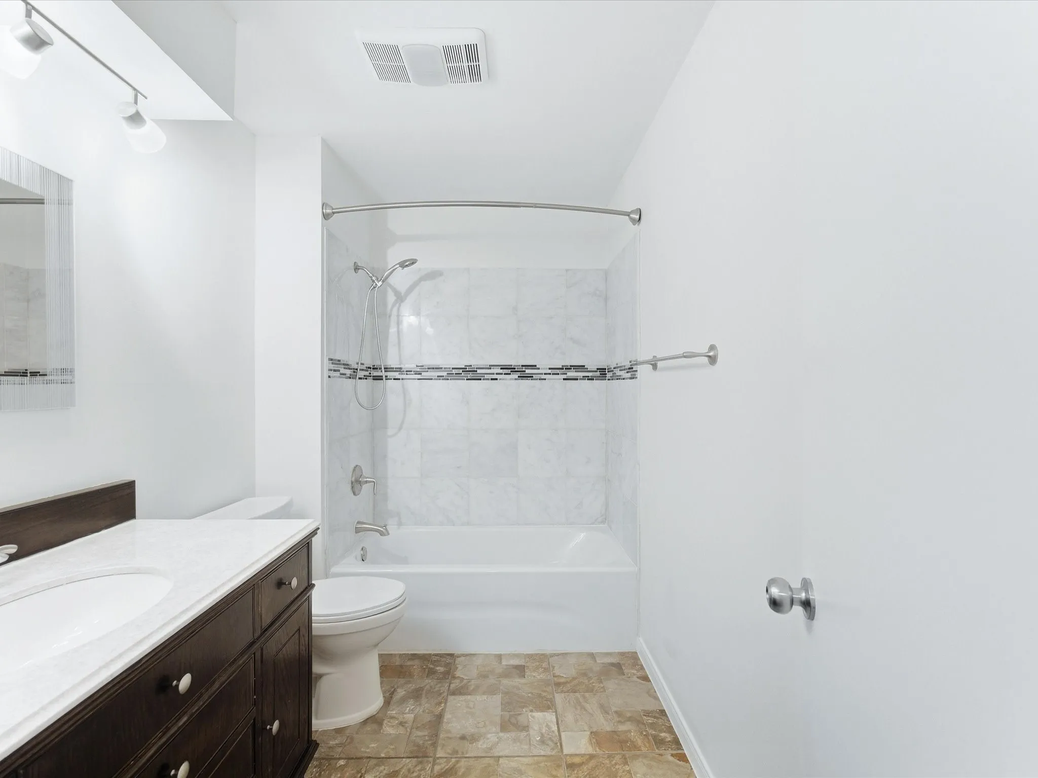 Dark wood-finish vanity with a white countertop and integrated sink