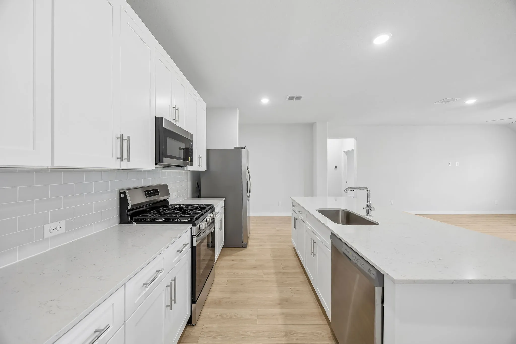 Kitchen in the Heisman home plan by Trophy Signature Homes – REPRESENTATIVE PHOTO