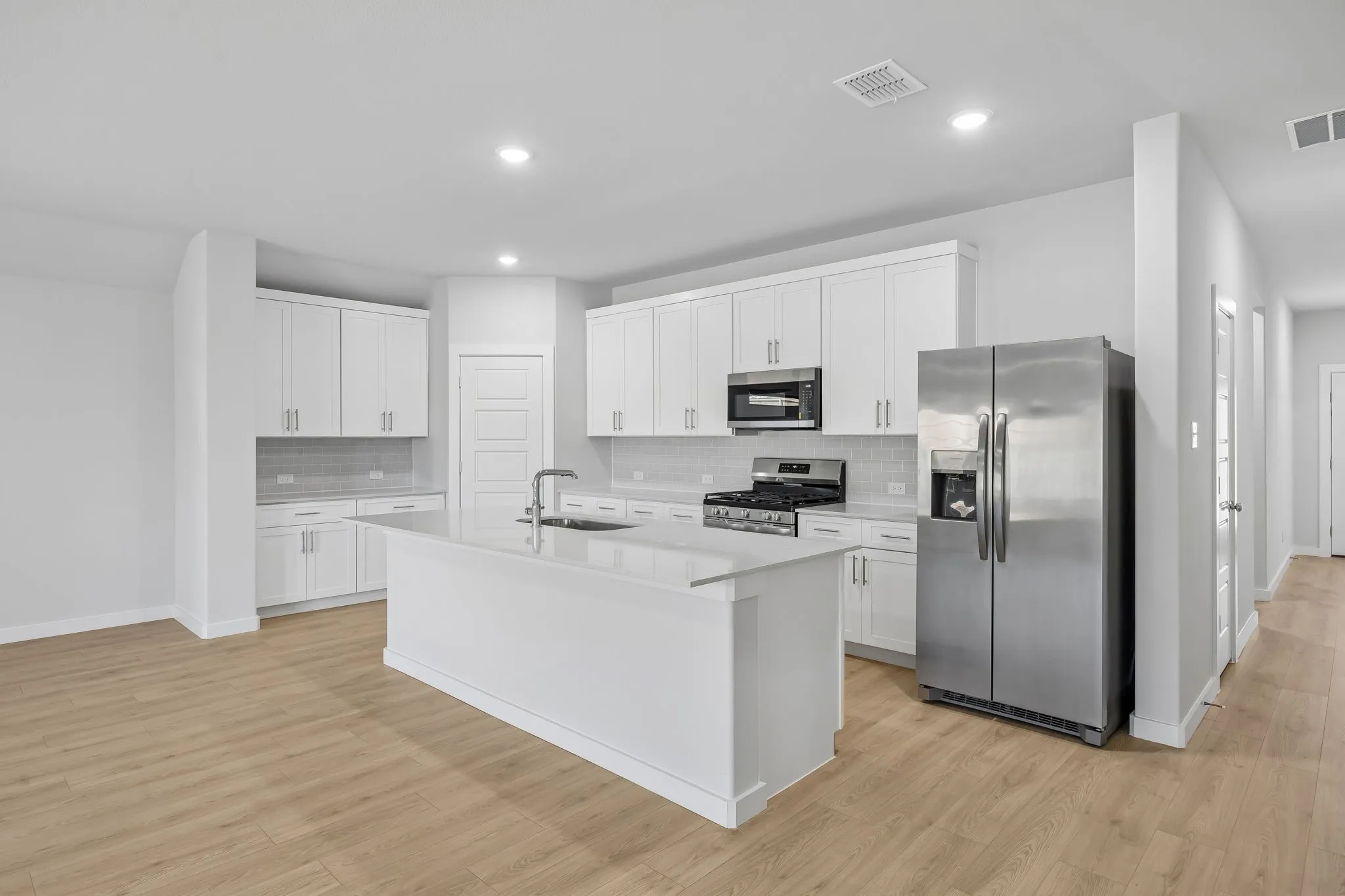 Kitchen in the Heisman home plan by Trophy Signature Homes – REPRESENTATIVE PHOTO
