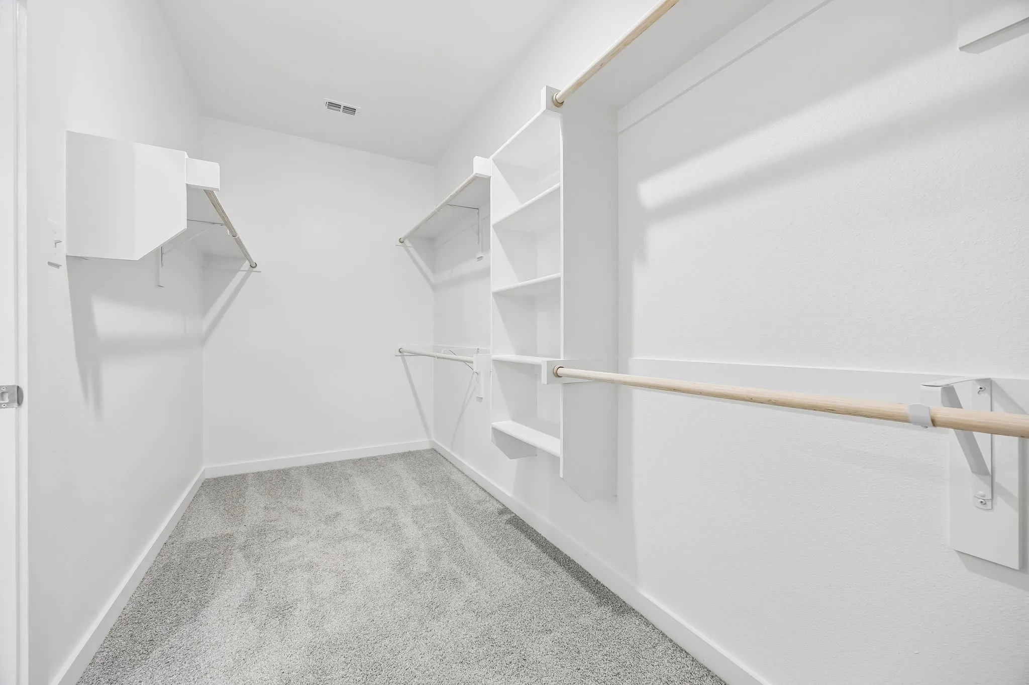 Walk-in closet in the Heisman home plan by Trophy Signature Homes – REPRESENTATIVE PHOTO