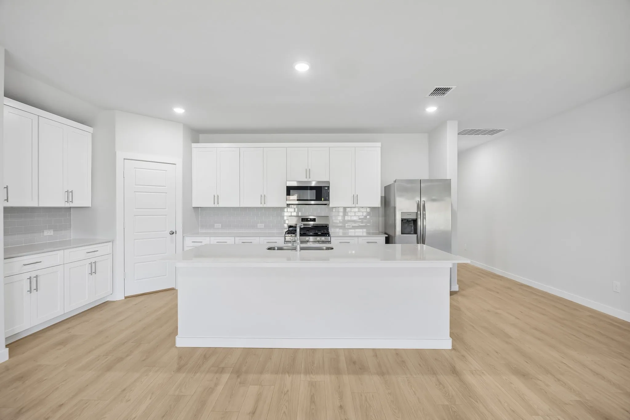 Kitchen in the Heisman home plan by Trophy Signature Homes – REPRESENTATIVE PHOTO