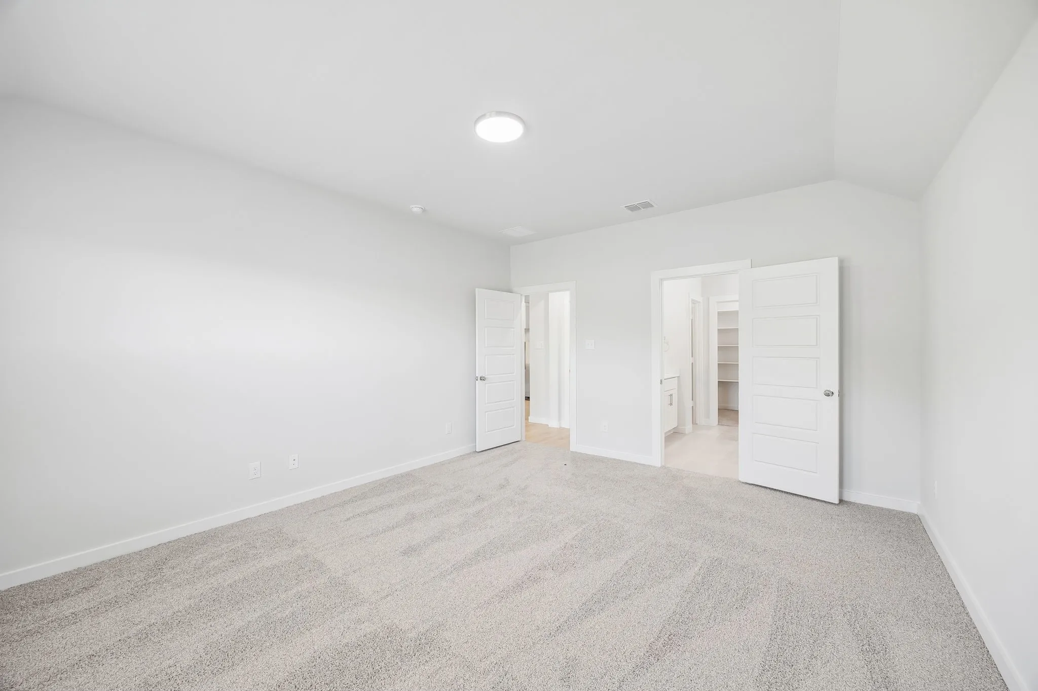 Primary bedroom in the Heisman home plan by Trophy Signature Homes – REPRESENTATIVE PHOTO
