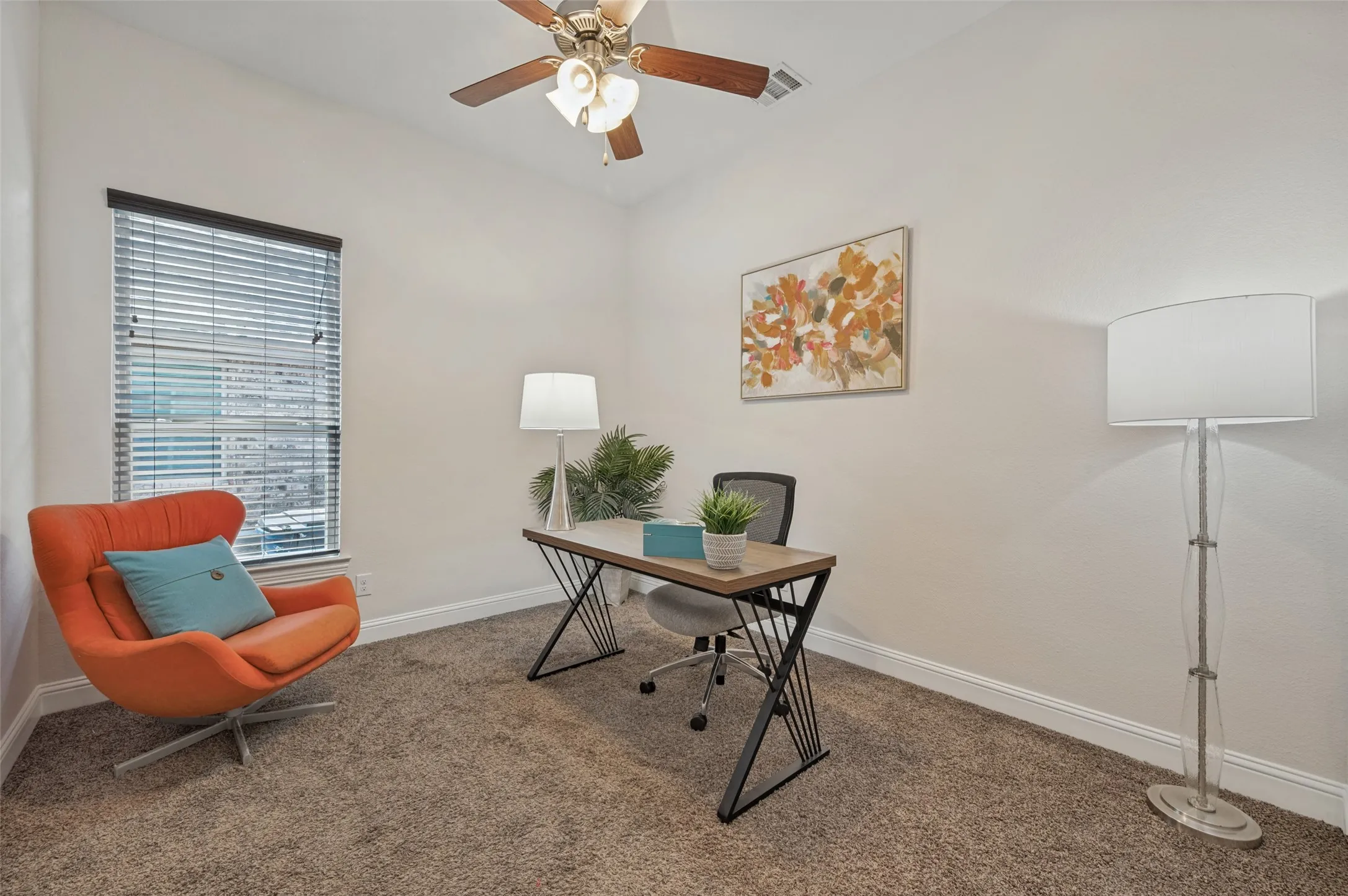 Carpeted room featuring a ceiling fan, a single window with blinds, and white walls
