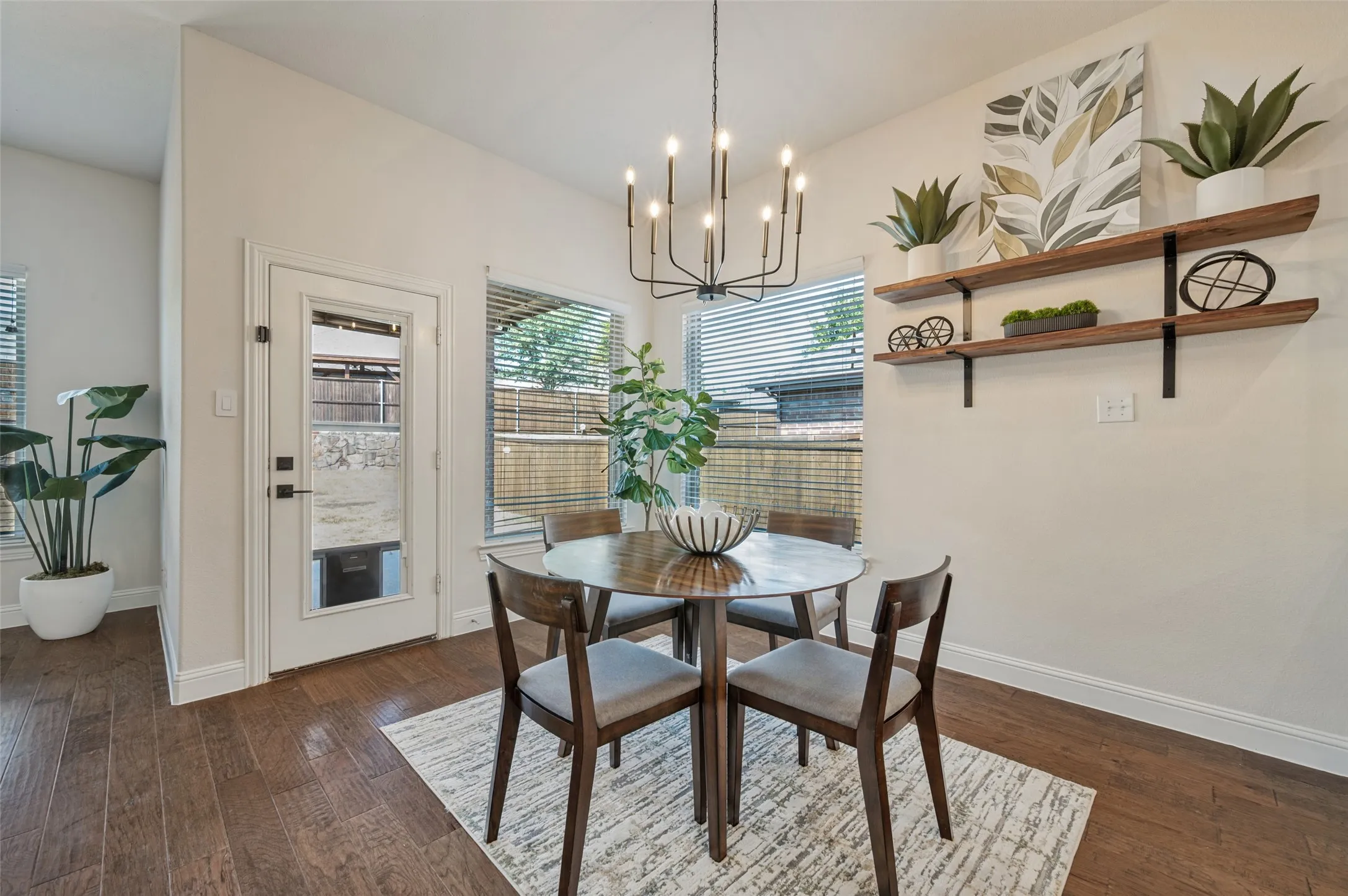 Recessed lighting, wood-finish flooring, and a modern chandelier