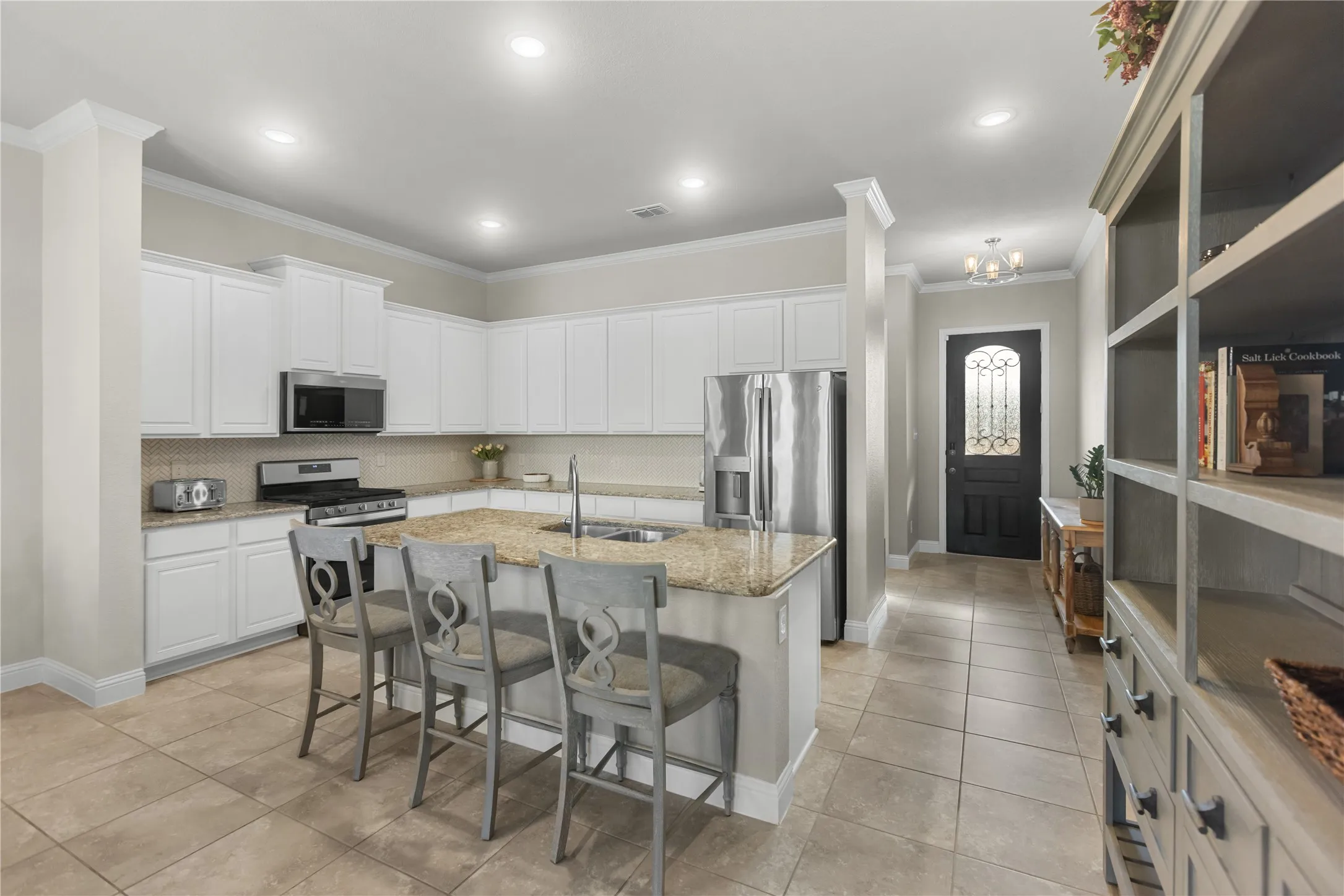 Gorgeous chef's kitchen made to entertain, tons of countertop space and cabinet storage. Featuring an oversized island with room for seating.