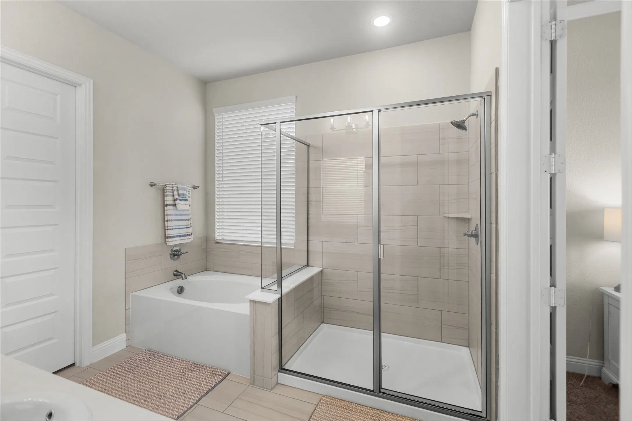 Spa-inspired primary bathroom featuring a relaxing soaking tub and separate walk-in shower.