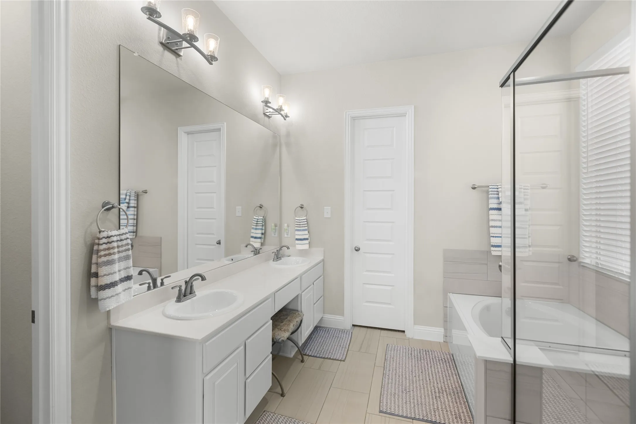 Primary bathroom with double sink, vanity space, and tons of countertop space. Private water closest.