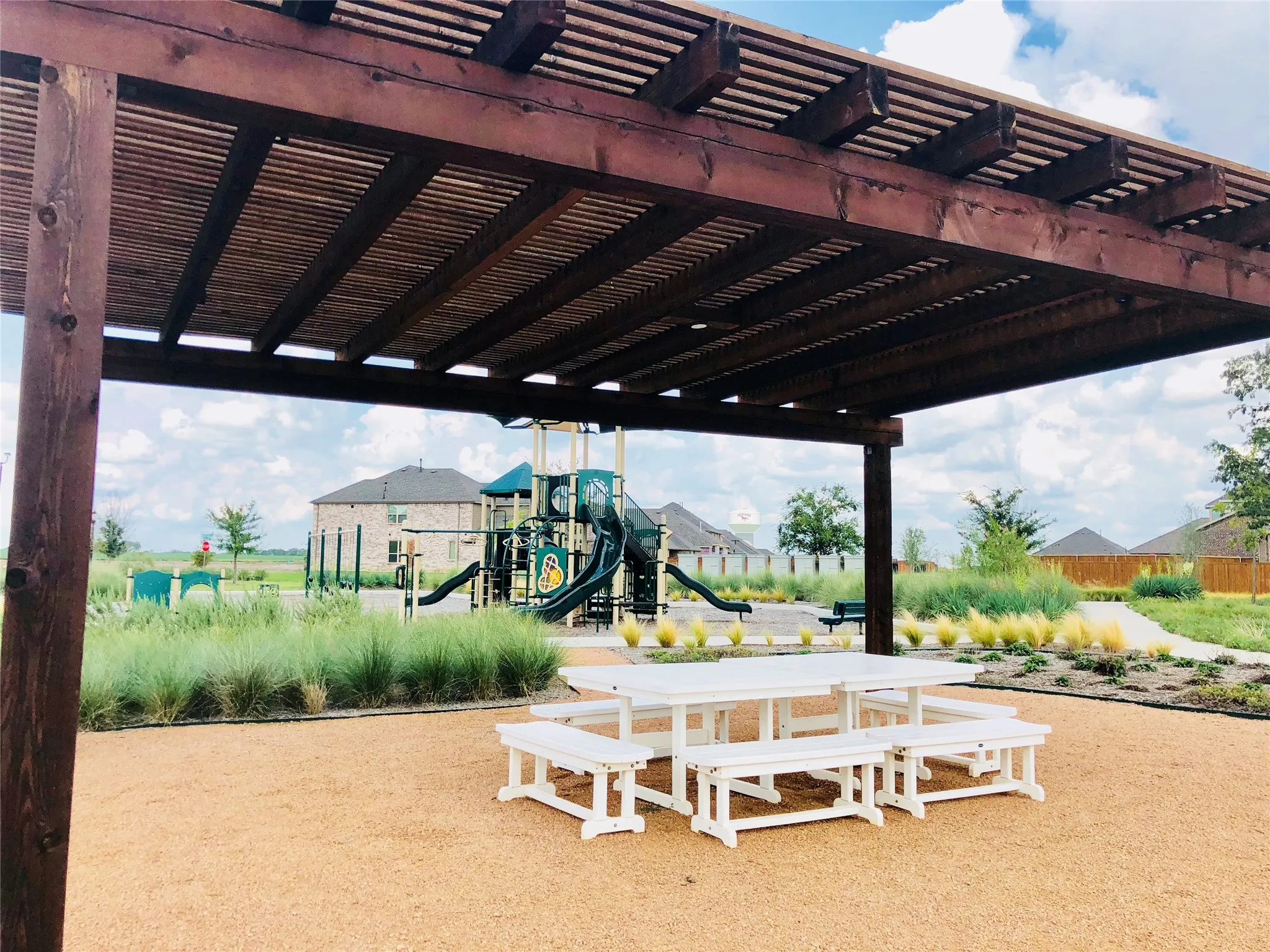 One of many community play spaces, with shaded areas and picnic tables!