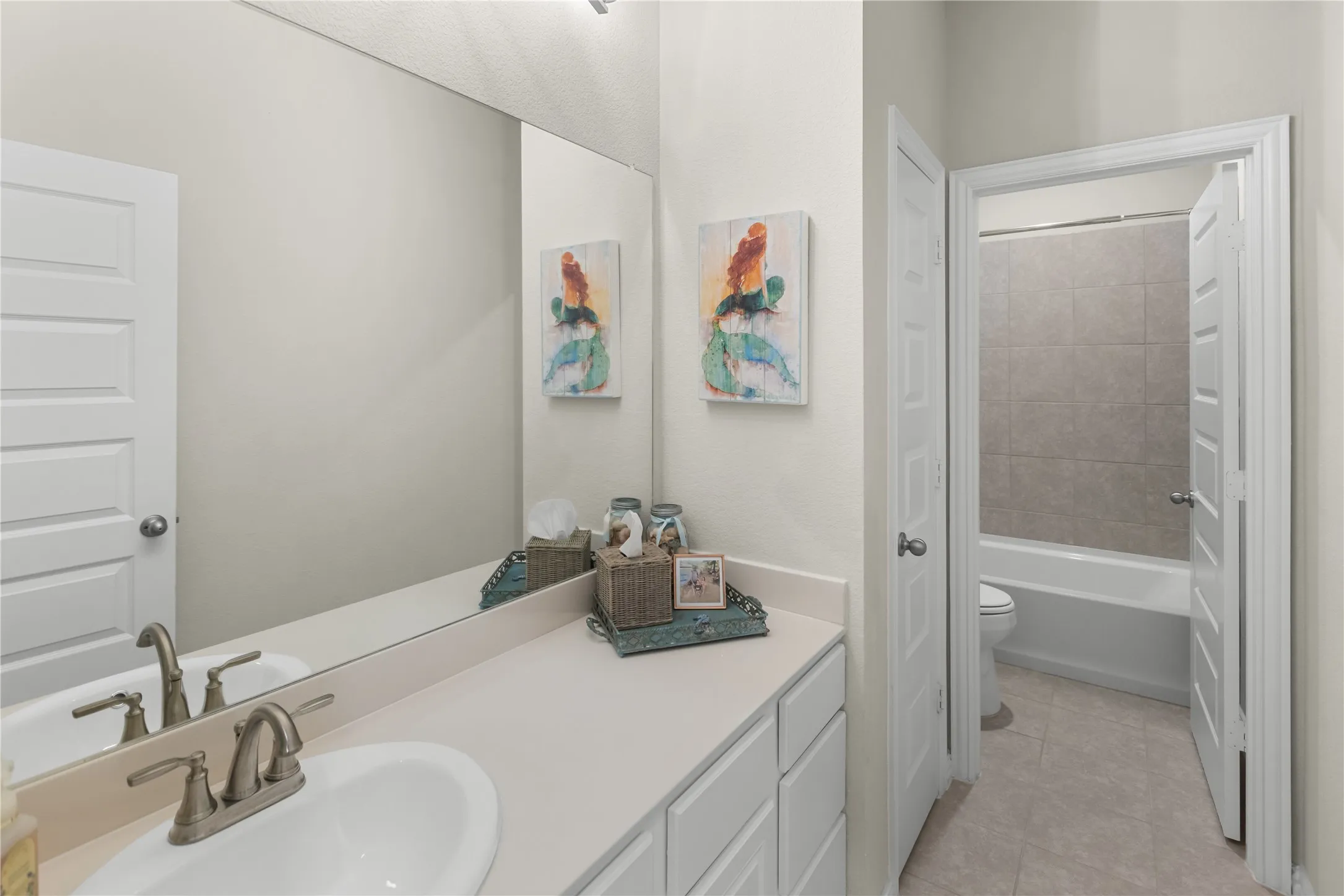 Upstairs bathroom featuring abundant counter space, a convenient linen closet, and a separate enclosed shower room.