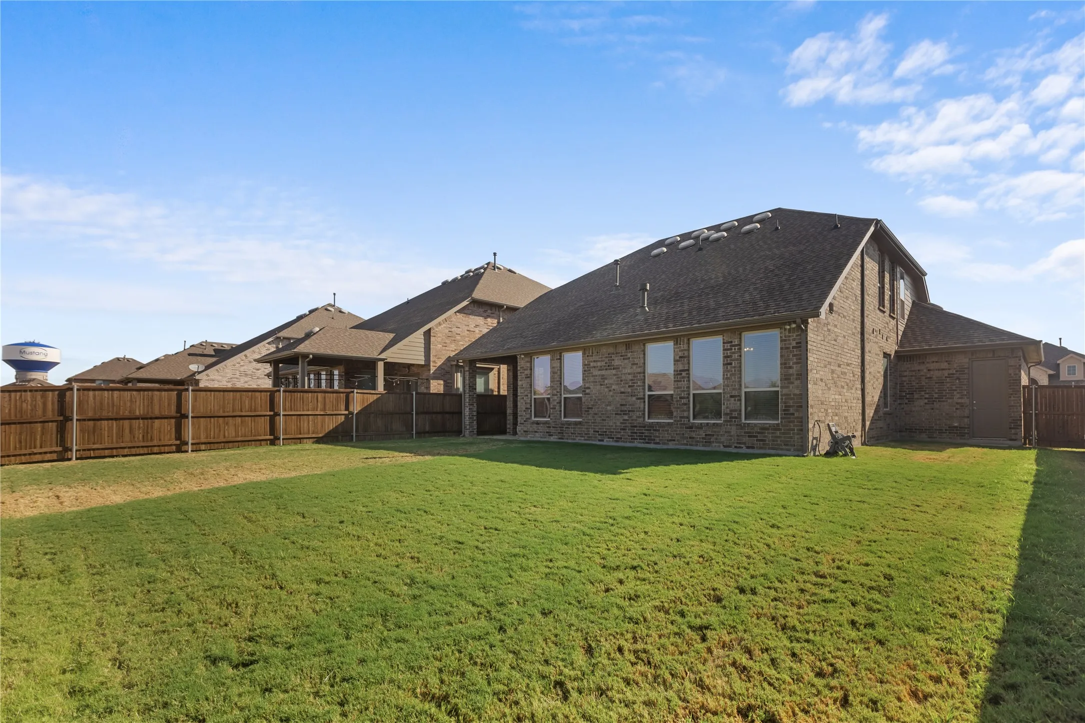 Spacious backyard with convenient direct access to the 3-car garage.