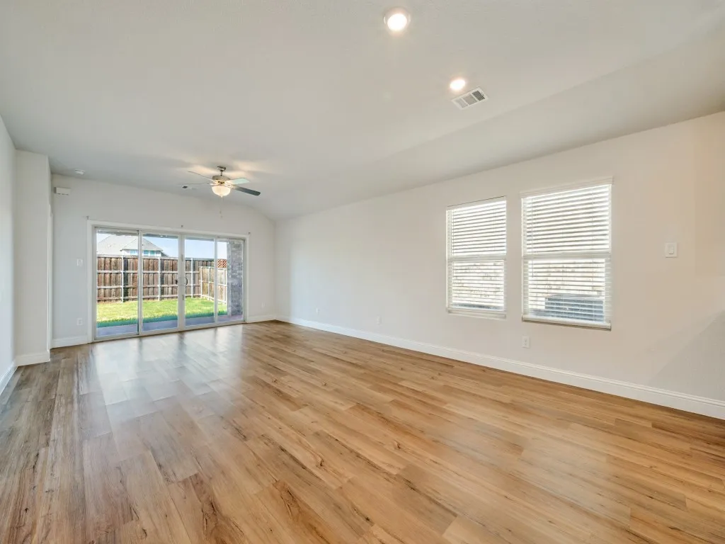 Wood-finish flooring, recessed lighting, and a ceiling fan