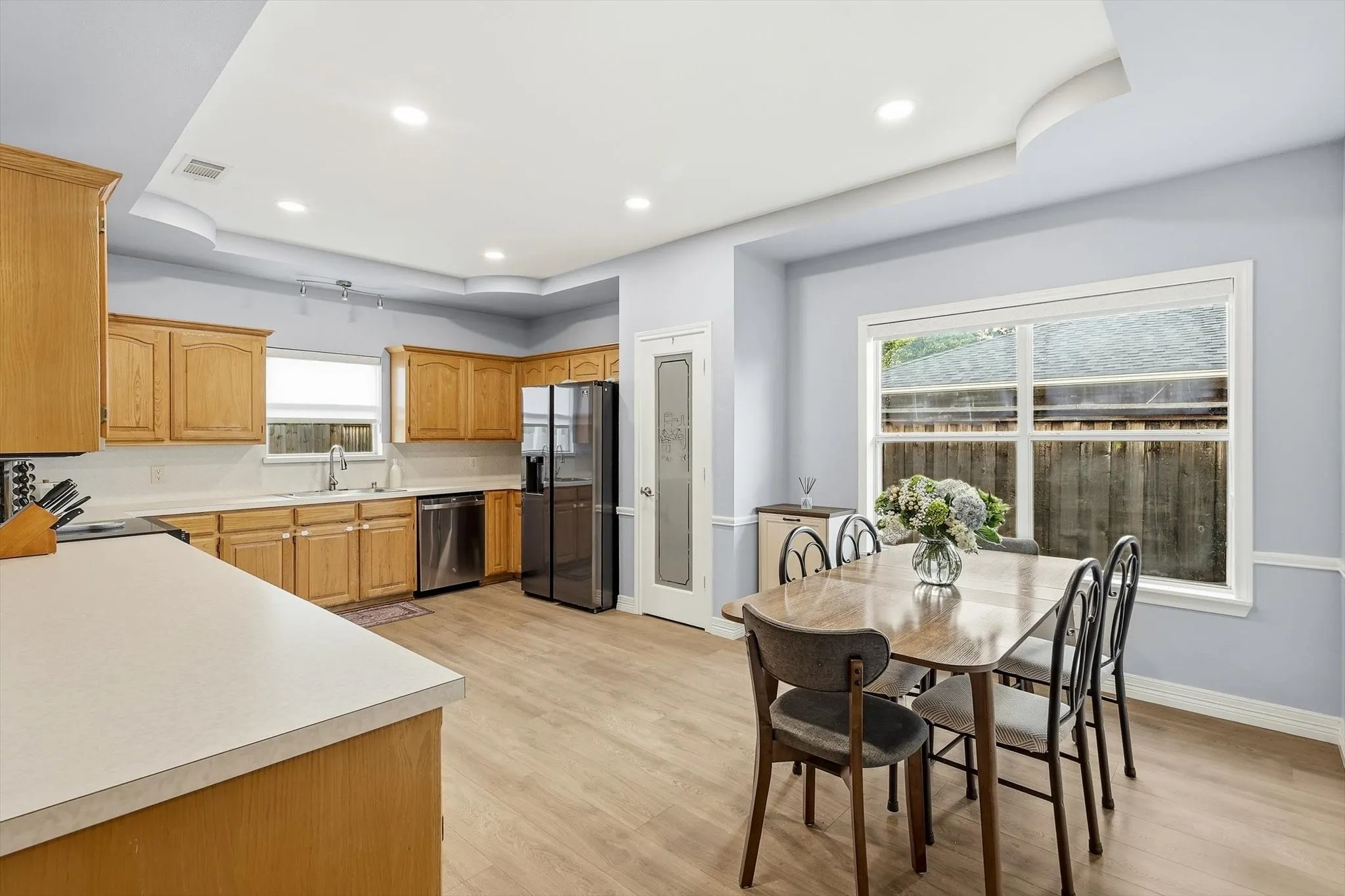 Kitchen and dining, loaded with natural light, ample counter space, a pantry, built-in wood cabinets featuring tons of storage
