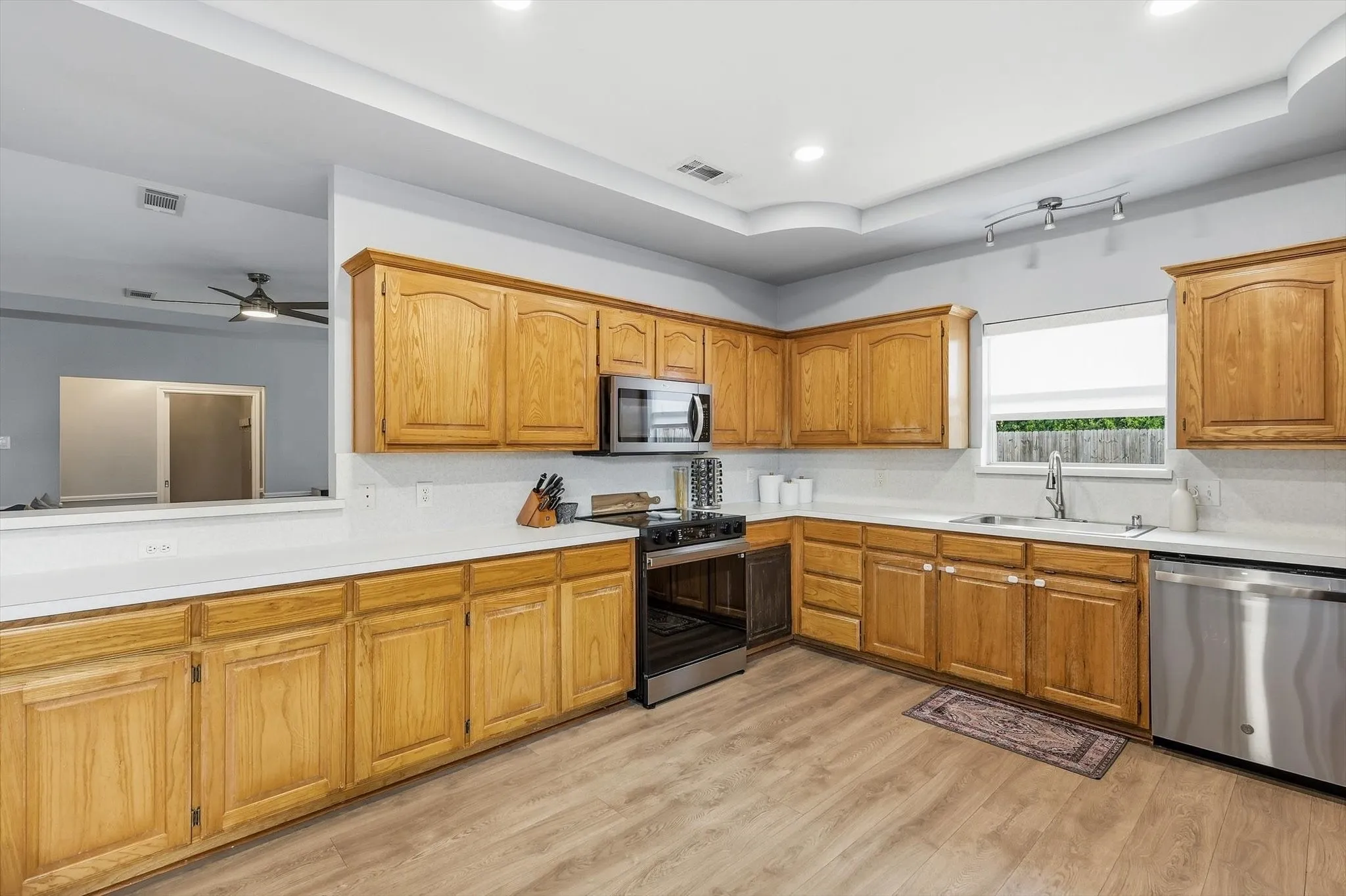 Kitchen overlooking the living space with an adorable accent window facing the backyard