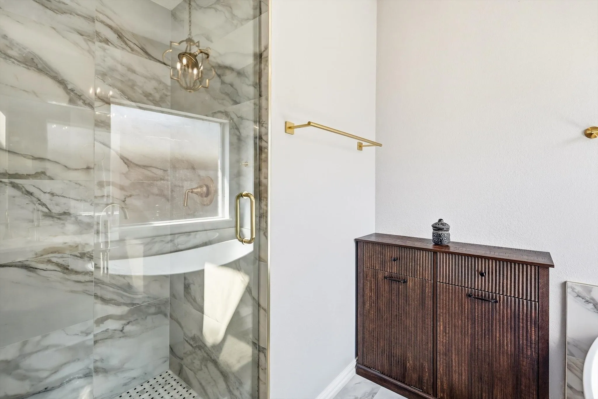 UPDATED primary ensuite bathroom with a stunning glass door walk-in shower and gold accents throughout