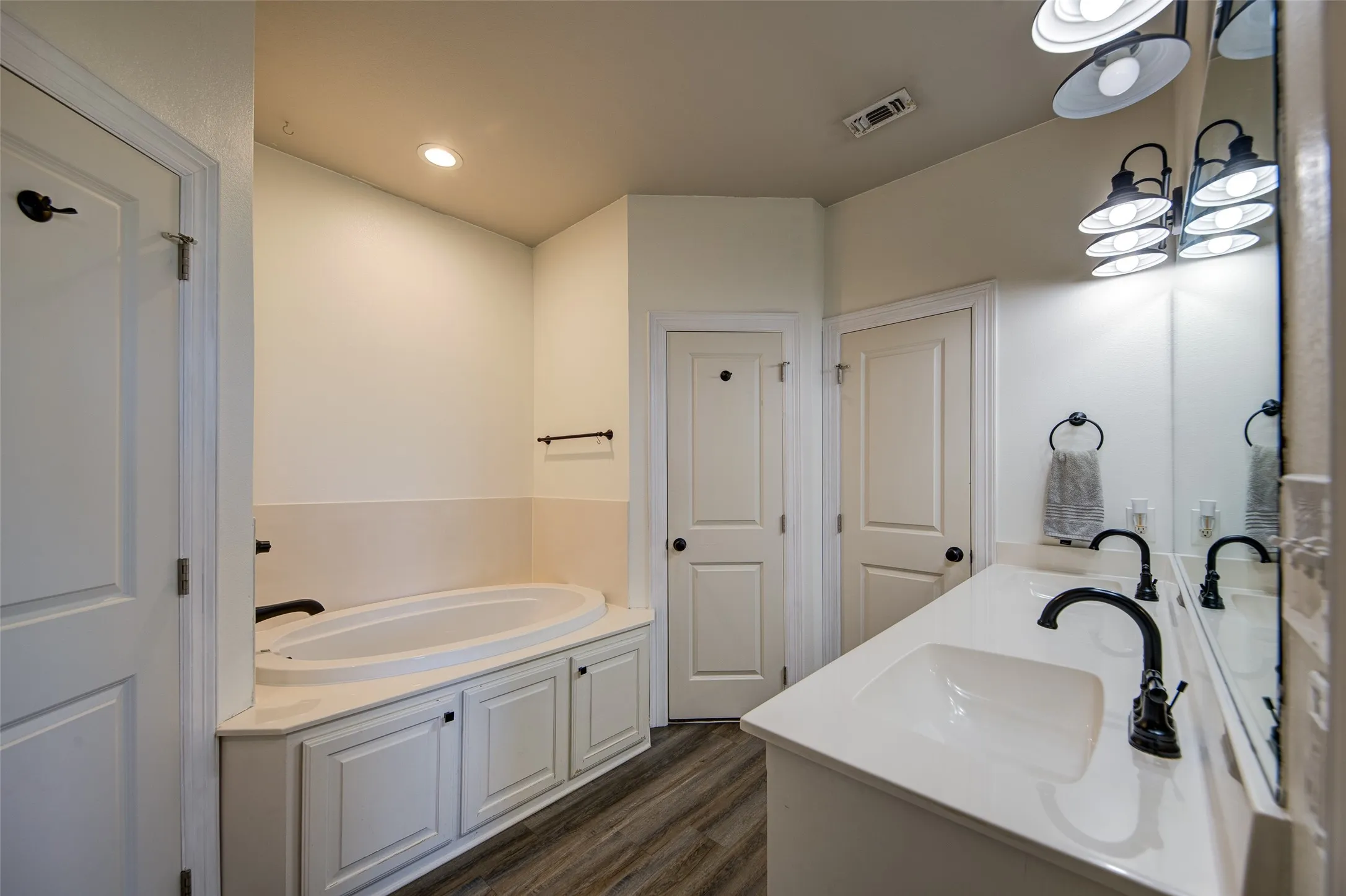 Primary bathroom with garden tub, double sinks dual closet, separate toilet room.