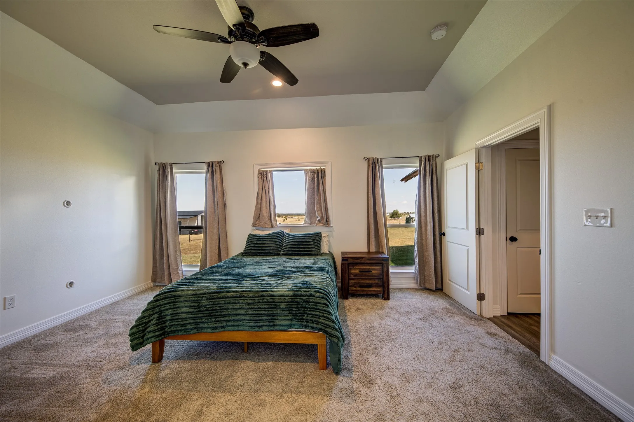 Primary bedroom with view of the back yard.