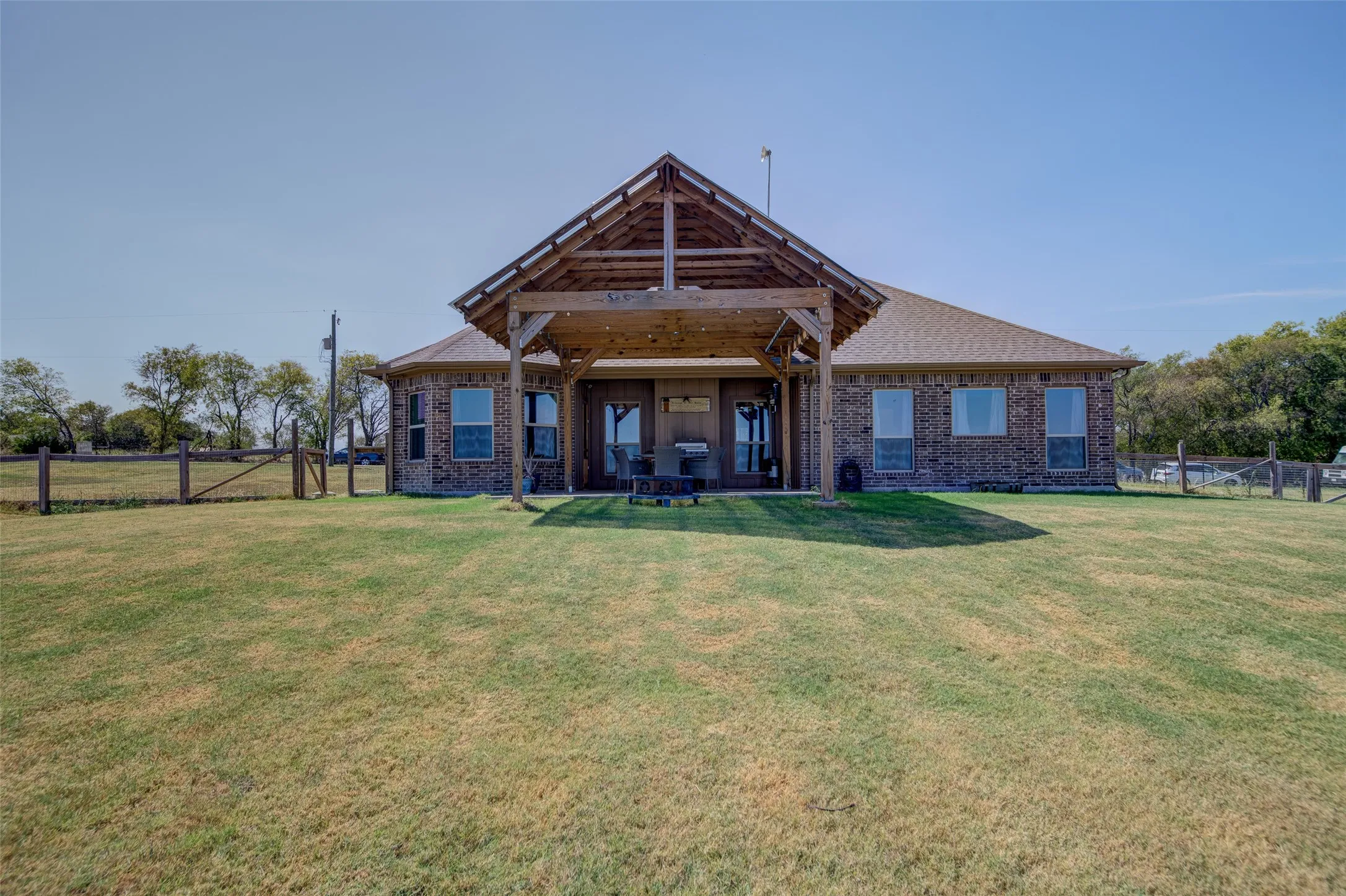Back of home with covered patio.
