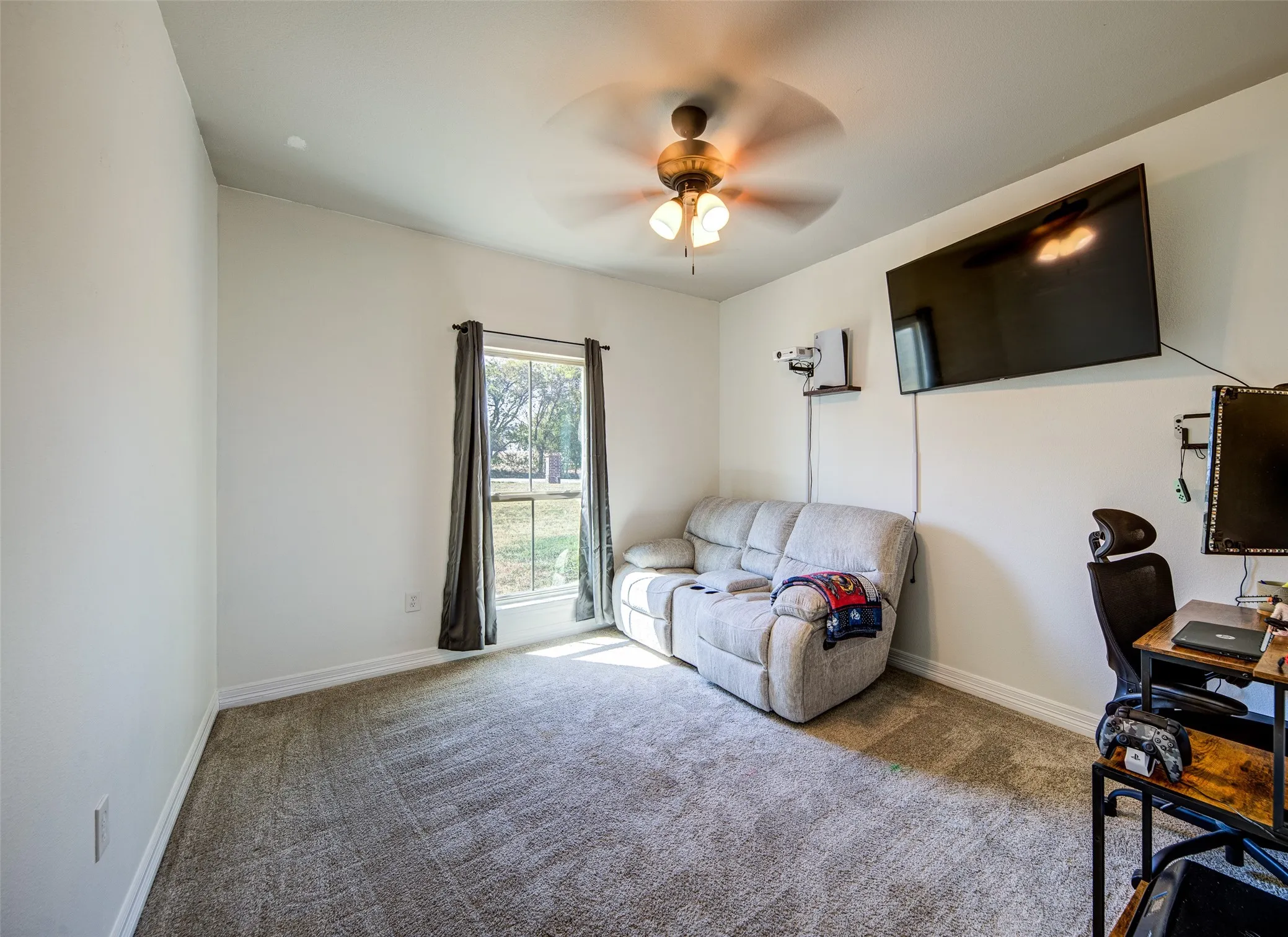 Guest bedroom currently used as an office with a walk-in closet.