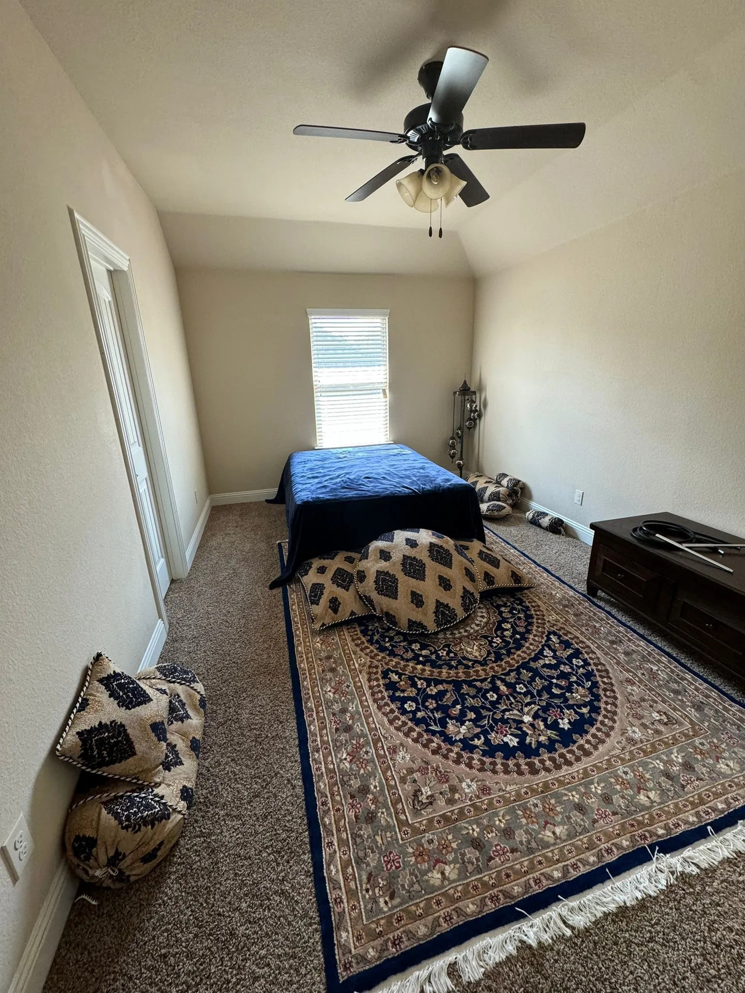 Bedroom with lofted ceiling, carpet flooring, and ceiling fan
