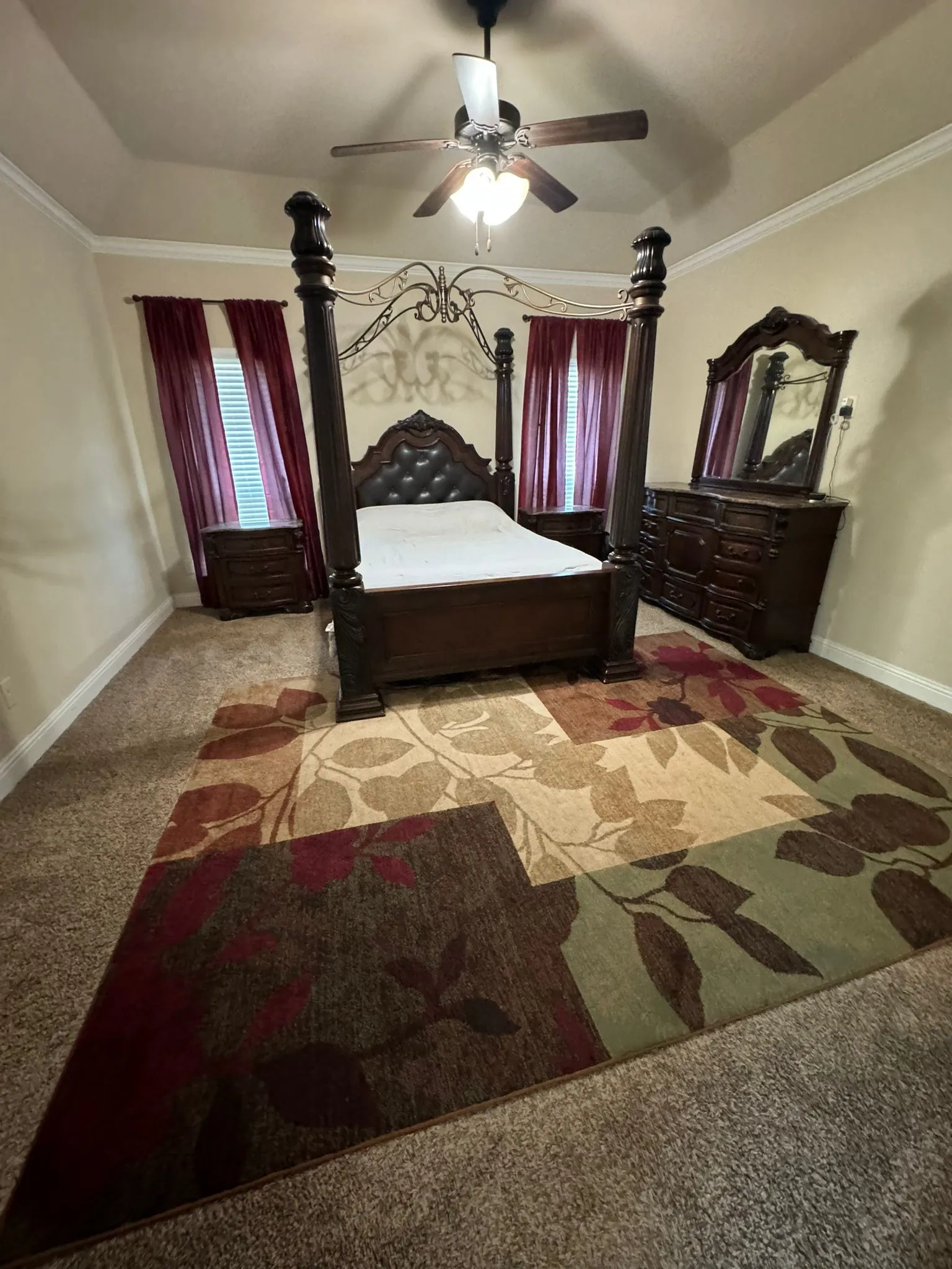 Carpeted bedroom with ceiling fan