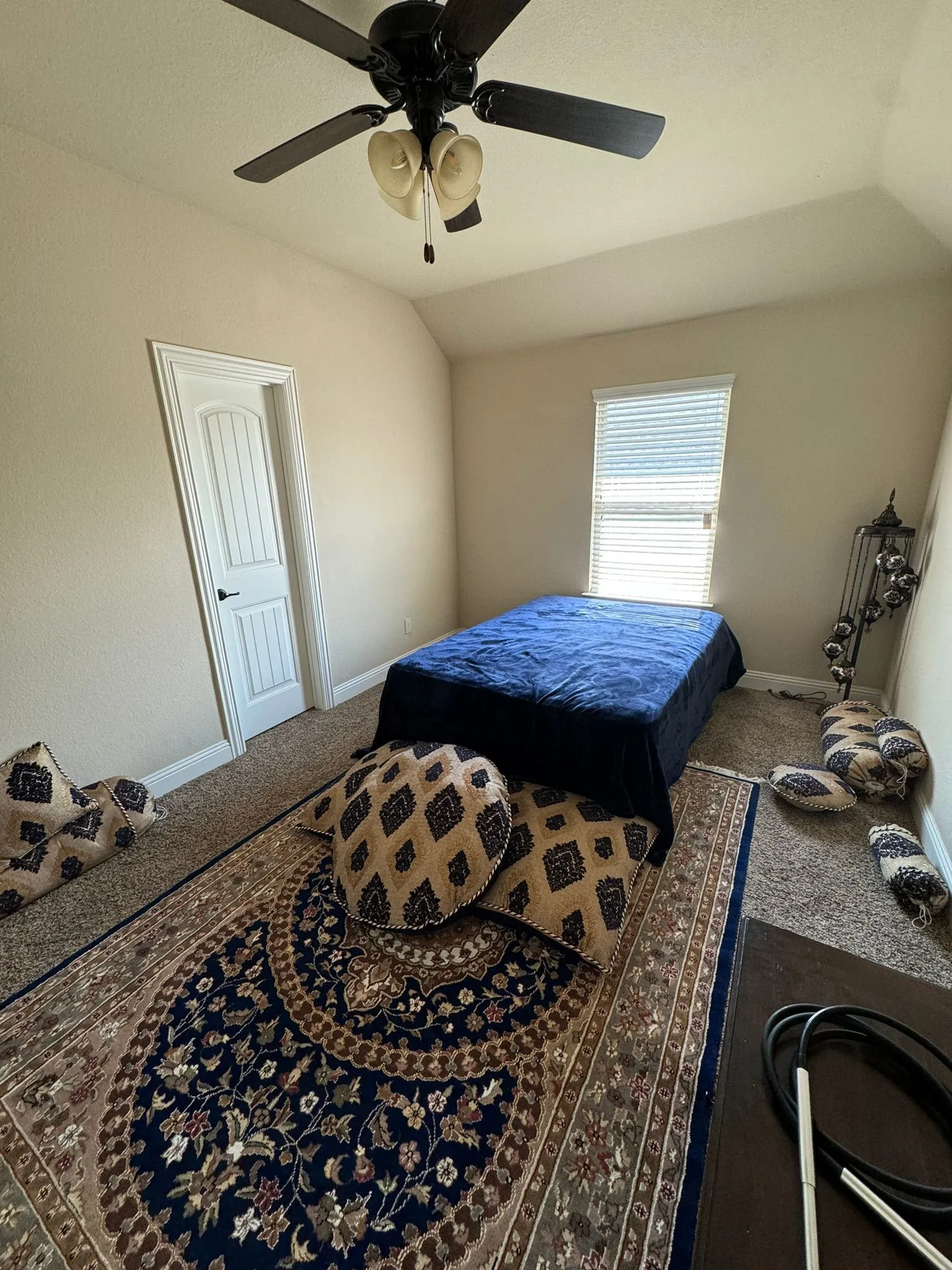Bedroom featuring carpet floors, ceiling fan, and vaulted ceiling