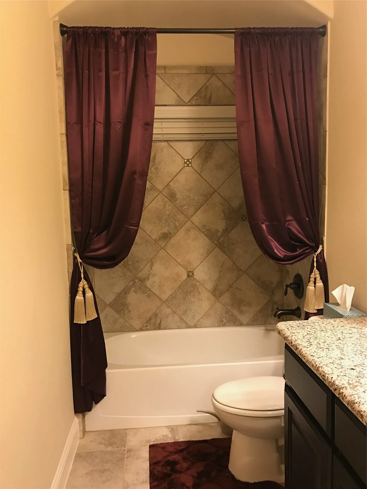 Full bathroom with vanity, tile patterned floors, toilet, and shower / bath combo