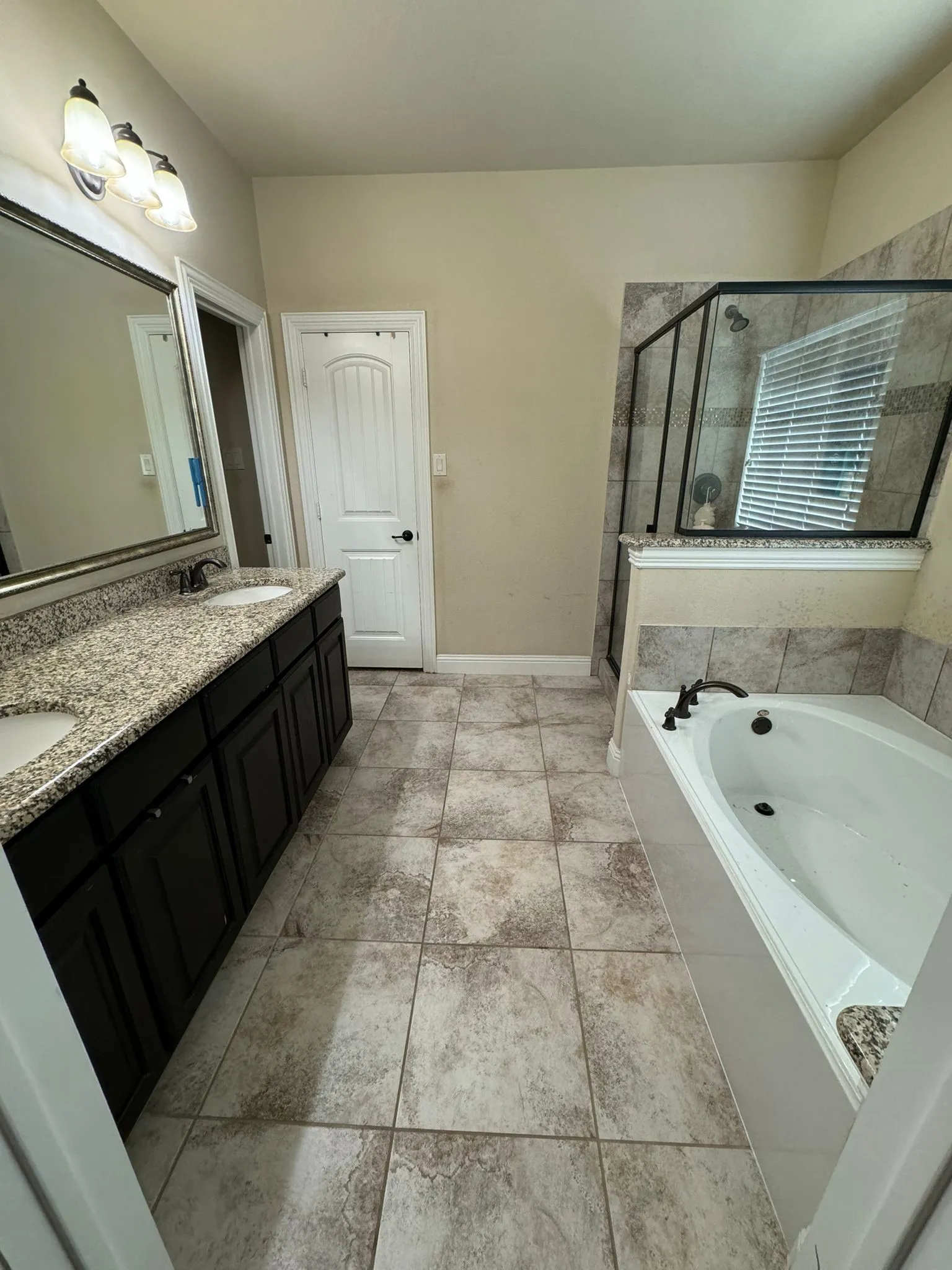 Bathroom featuring shower with separate bathtub, tile patterned floors, and dual bowl vanity