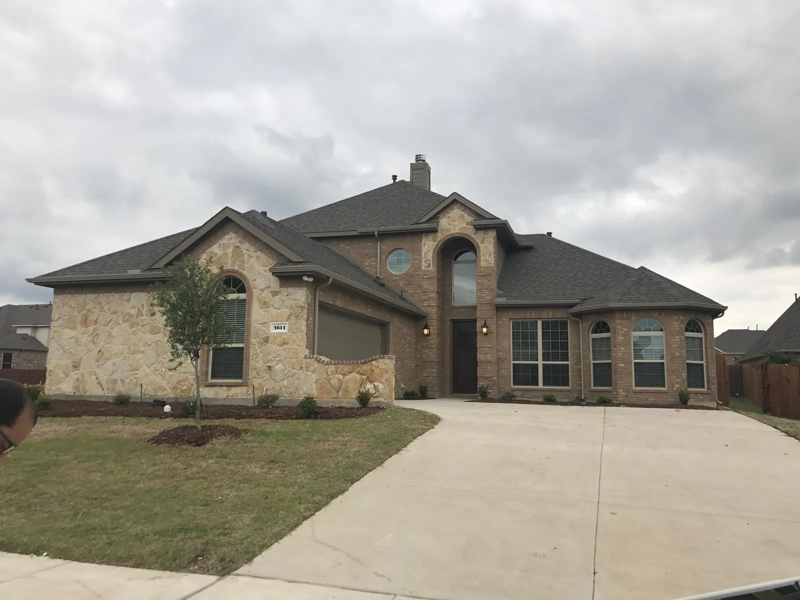 French country home with a garage and a front lawn