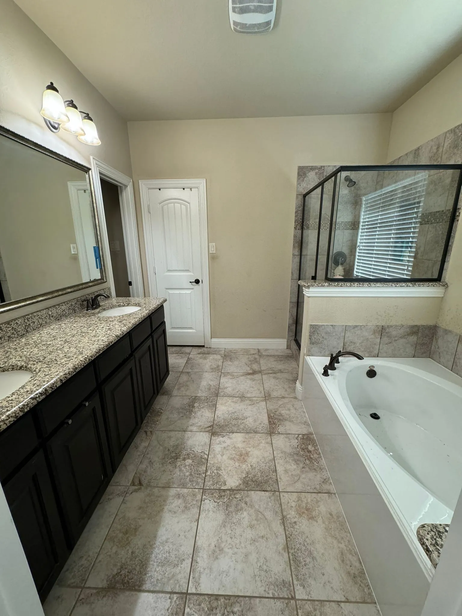 Bathroom with independent shower and bath, tile patterned flooring, and double sink vanity