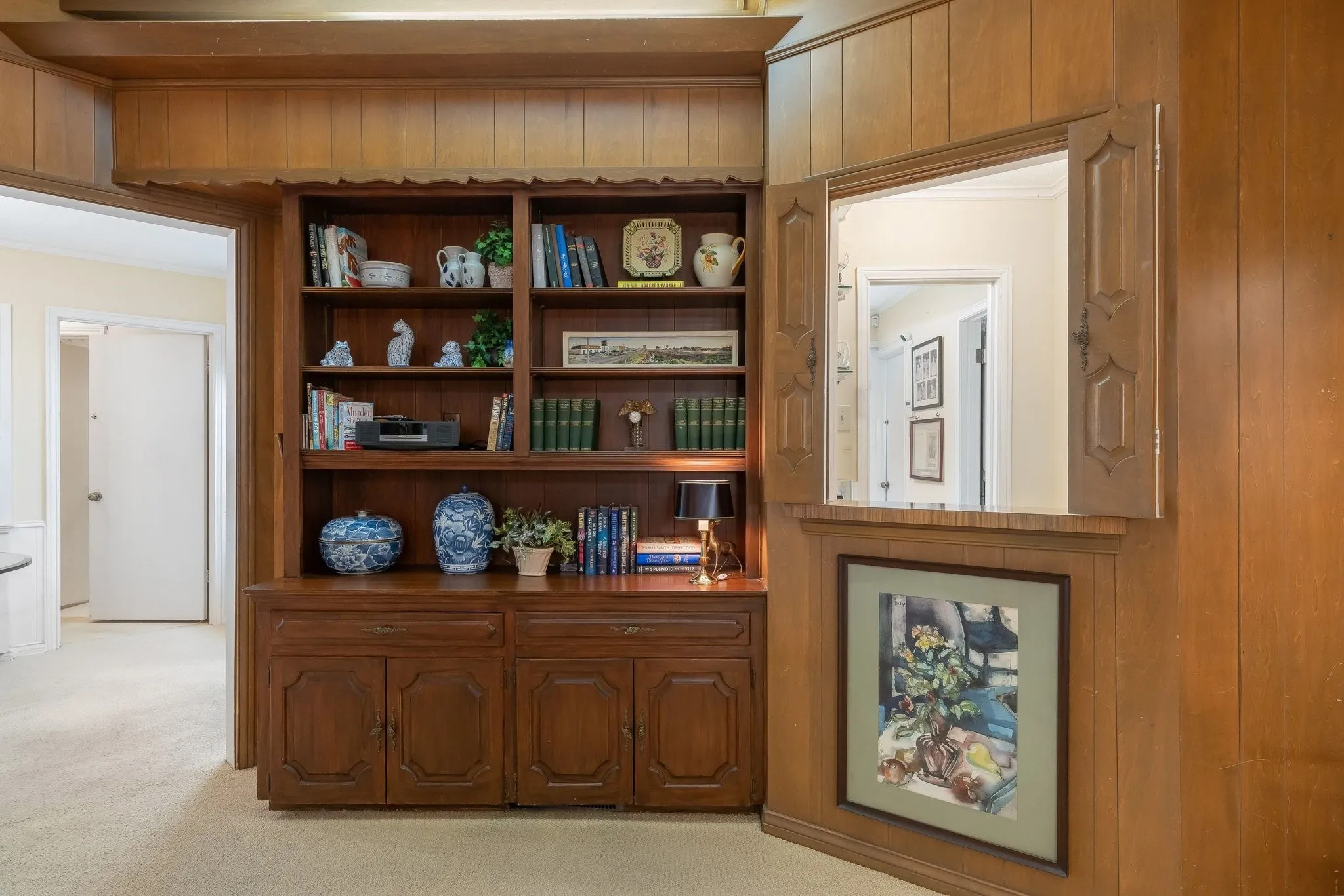 Family room with built in bookshelf and cabinets.