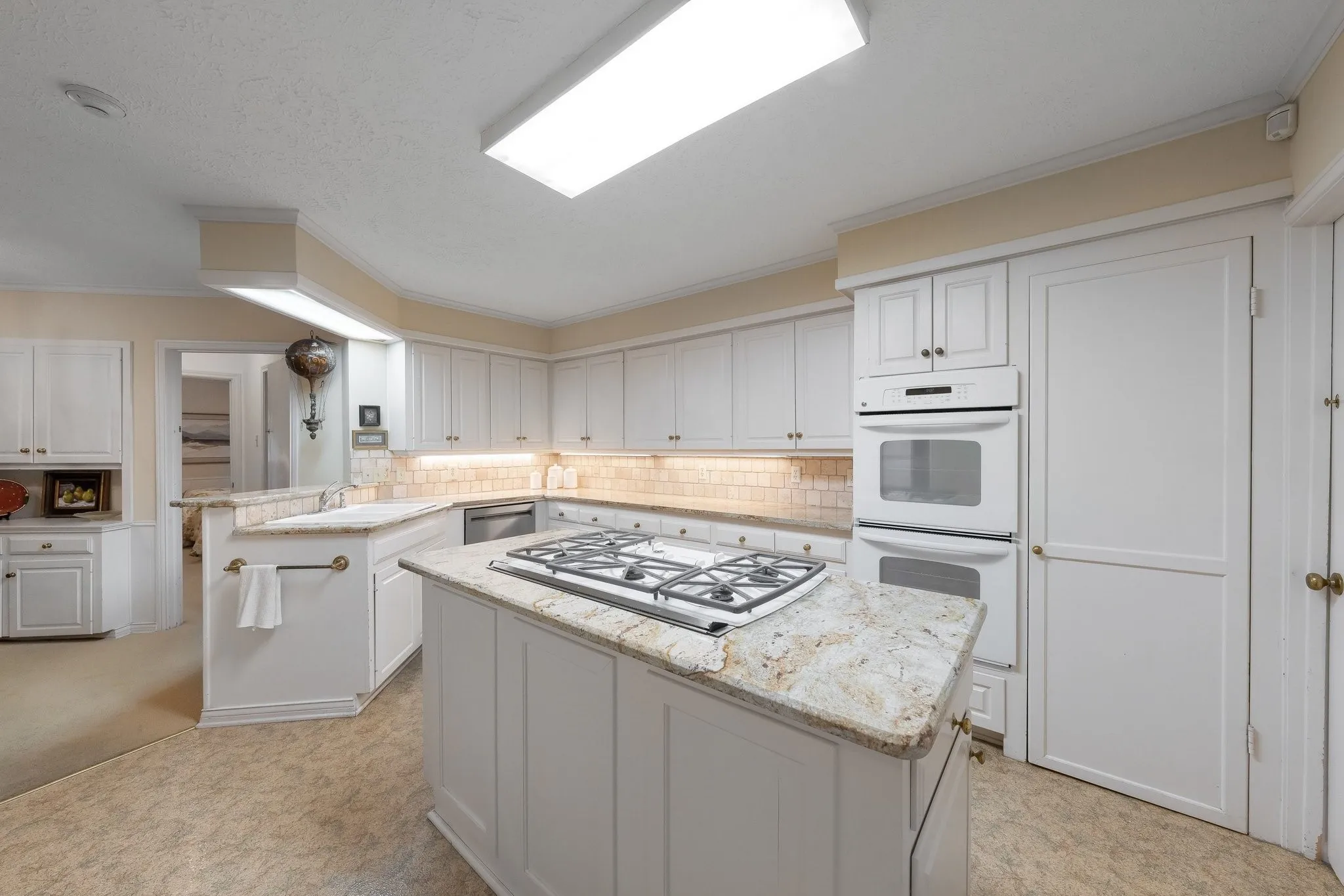 Island with 5 burner gas cooktop and downdraft.