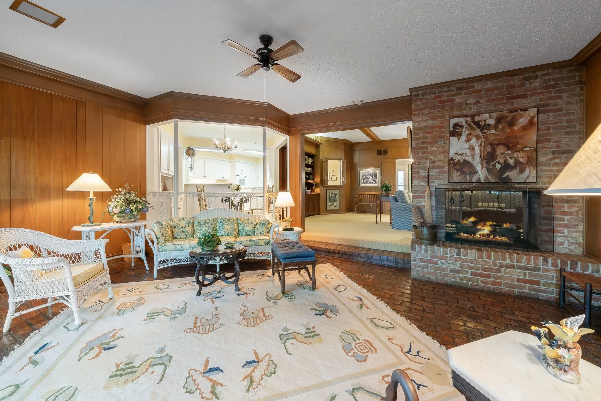 Sun Room with See Through Fireplace from the Family Room and brick flooring.