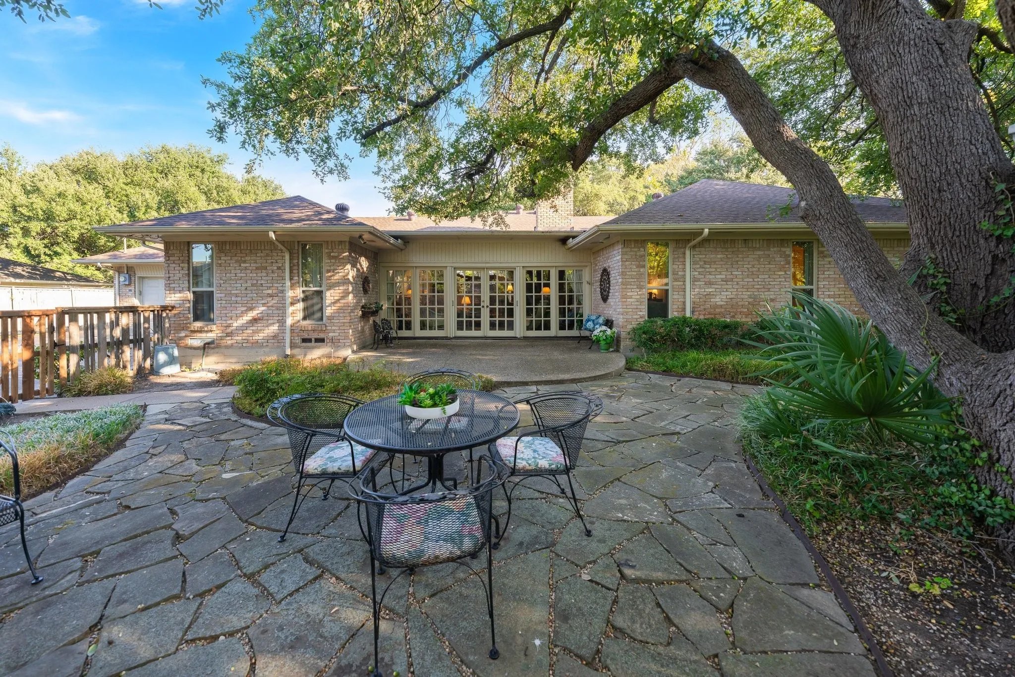 Back of home with plenty of entertaining areas and patios.