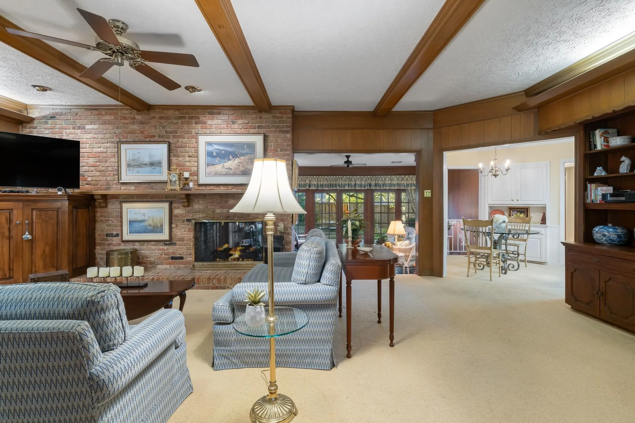 Family Room with beamed ceiling open to Kitchen and Sun Room.