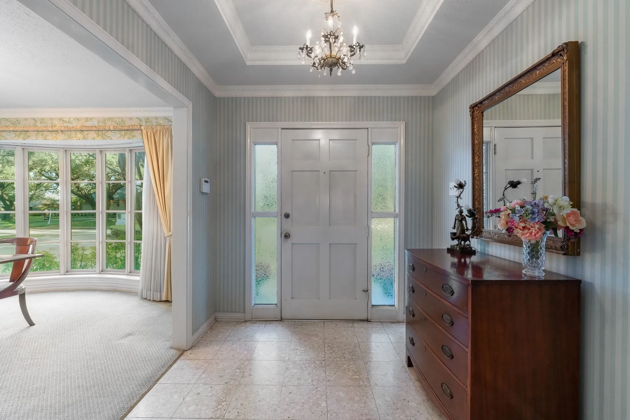 Entry with two coat closets on each side. Open to the Dining Room.