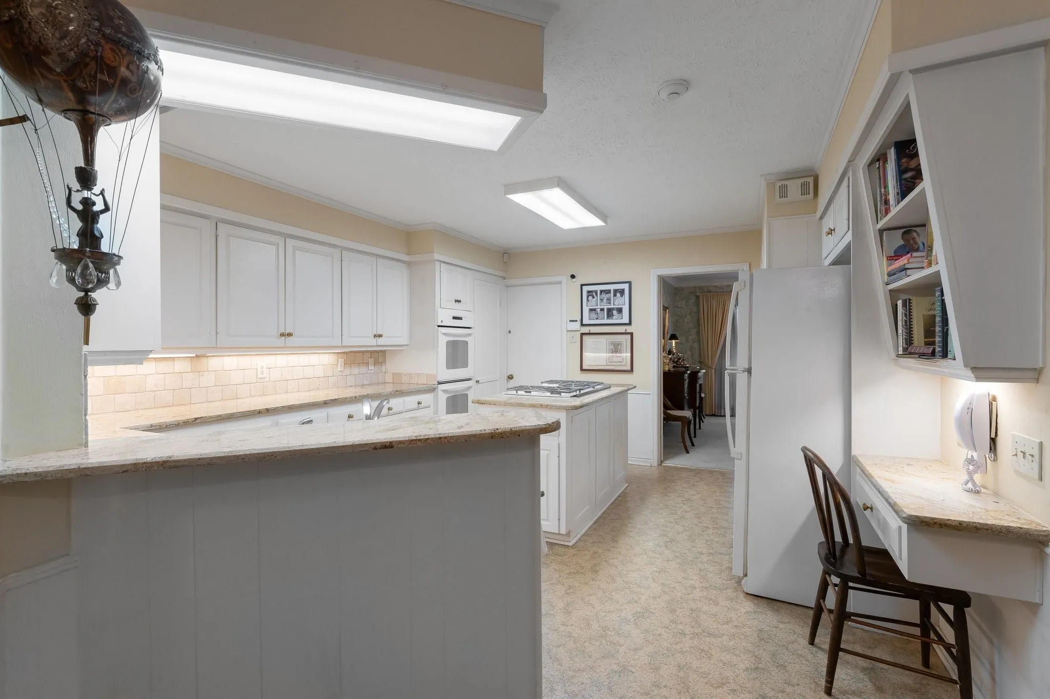 Built in desk area and cook book shelving.
