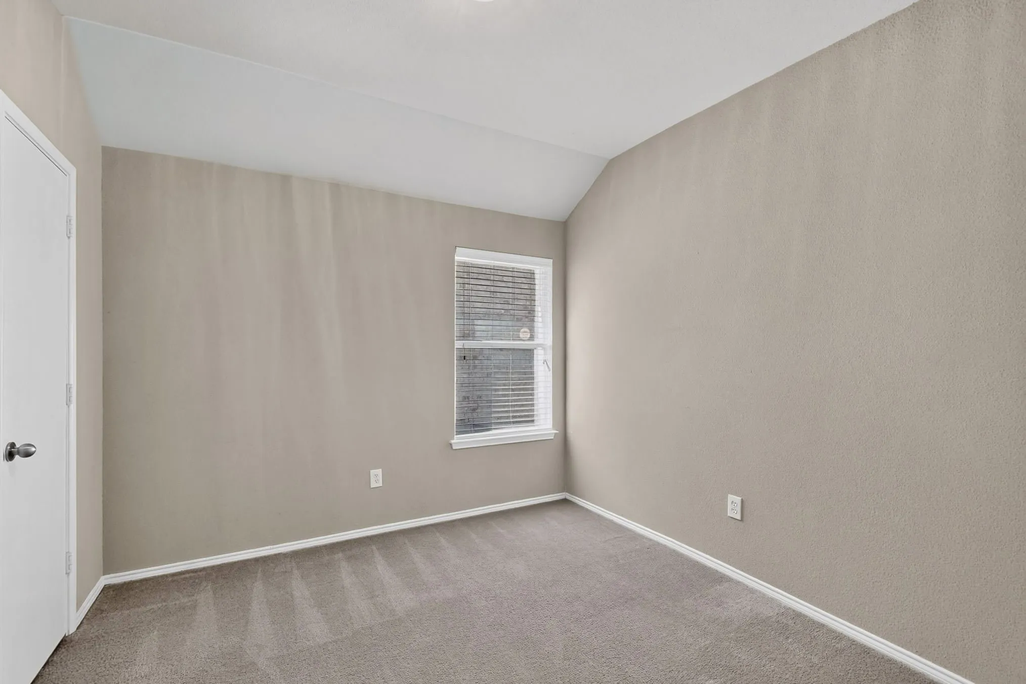 Neutral-toned walls complement the carpeted flooring