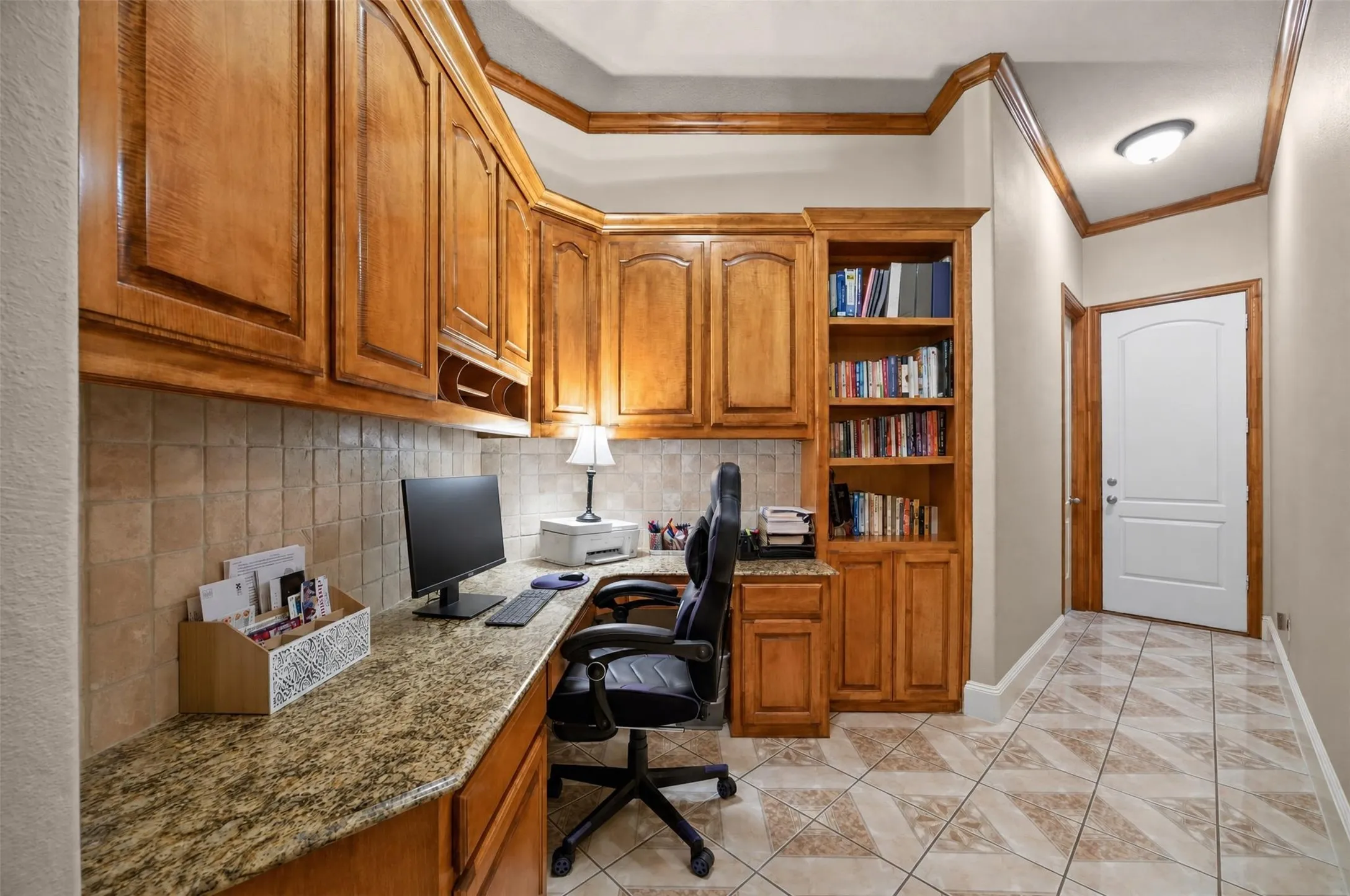 Office are with built-in desk and cabinetry.