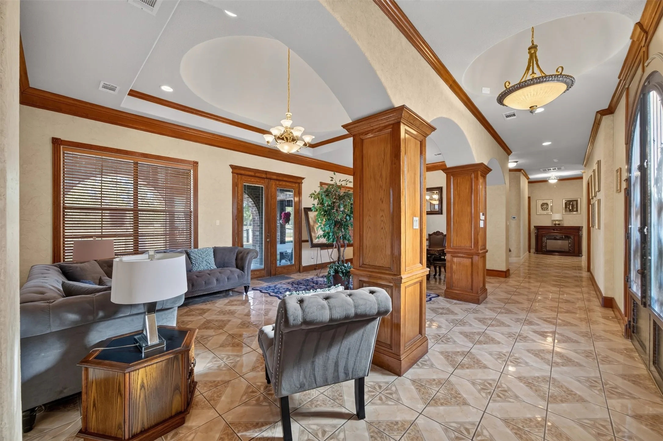 Formal living and dining with French doors leading to covered back patio