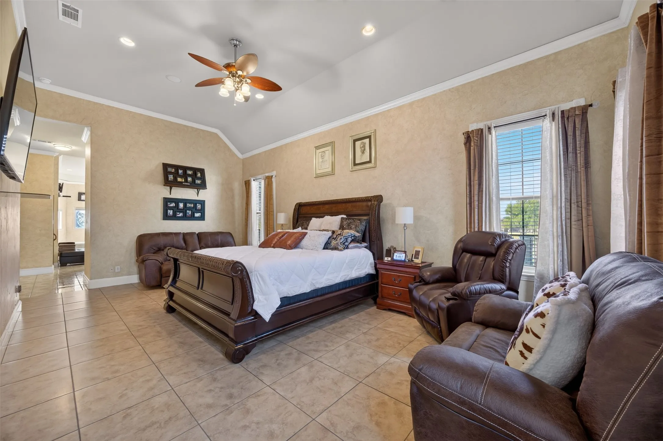 Oversize primary bedroom with soaring windows and sitting area