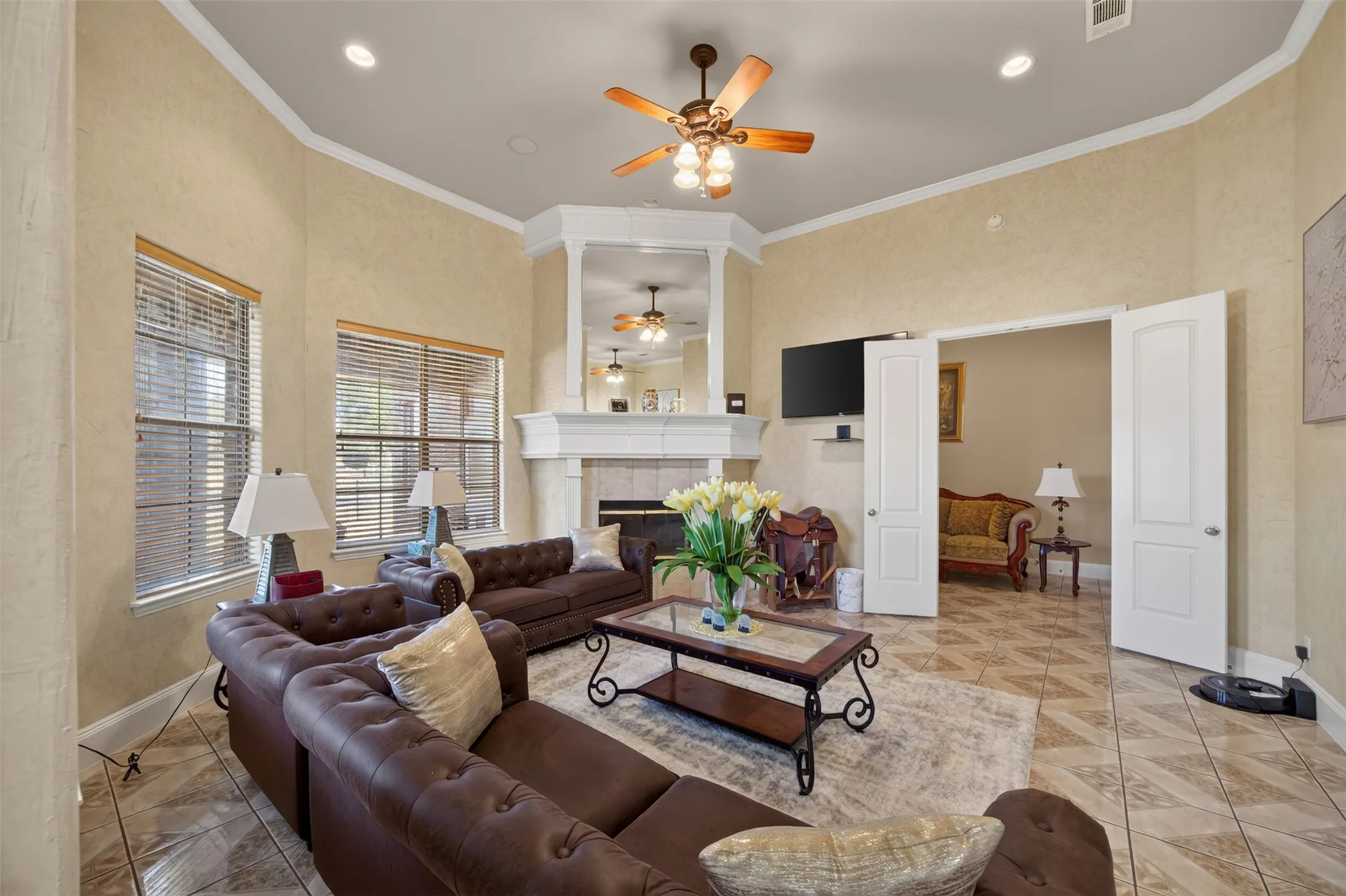 2nd living room with wood-burning fireplace and ceiling fan