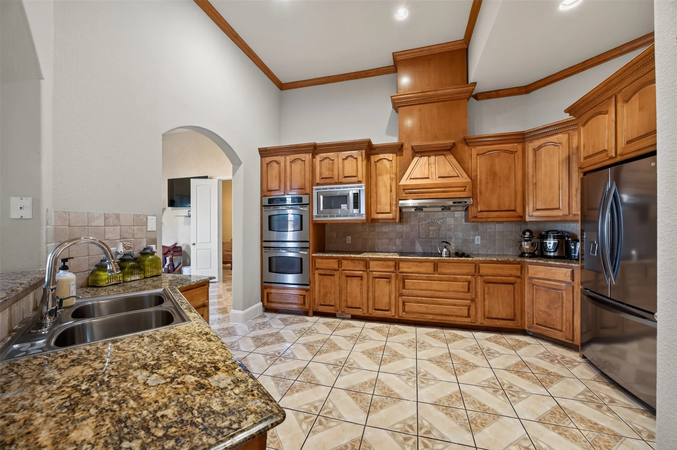 Kitchen with stainless steel double ovens, granite counters, abundant cabinetry
