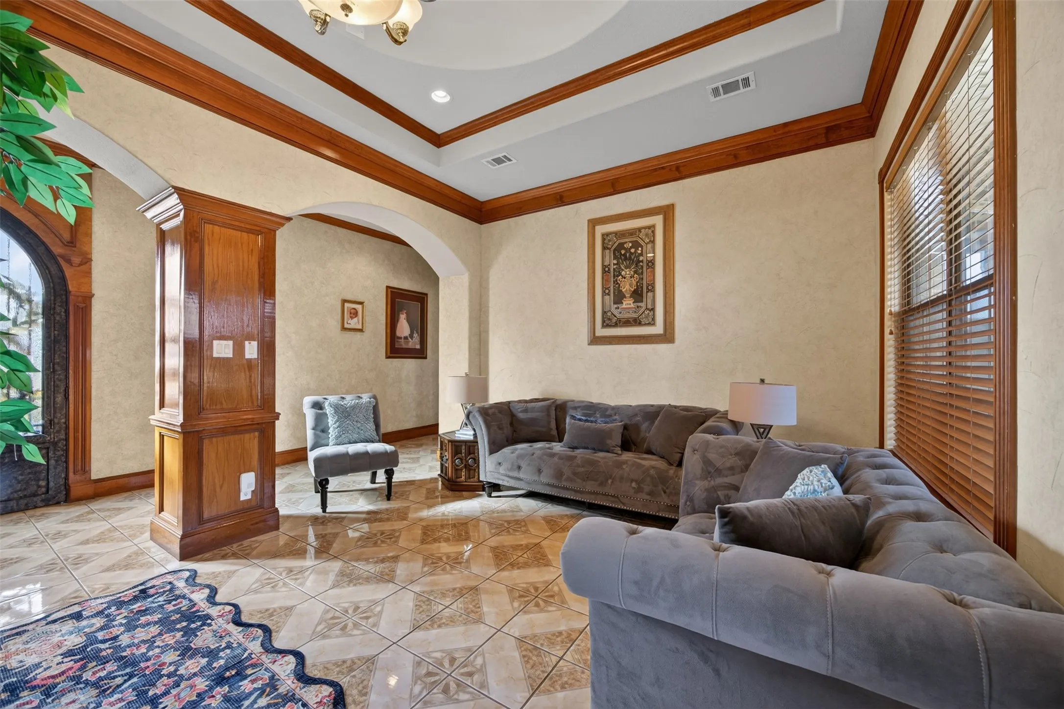 Formal living room with crown moulding