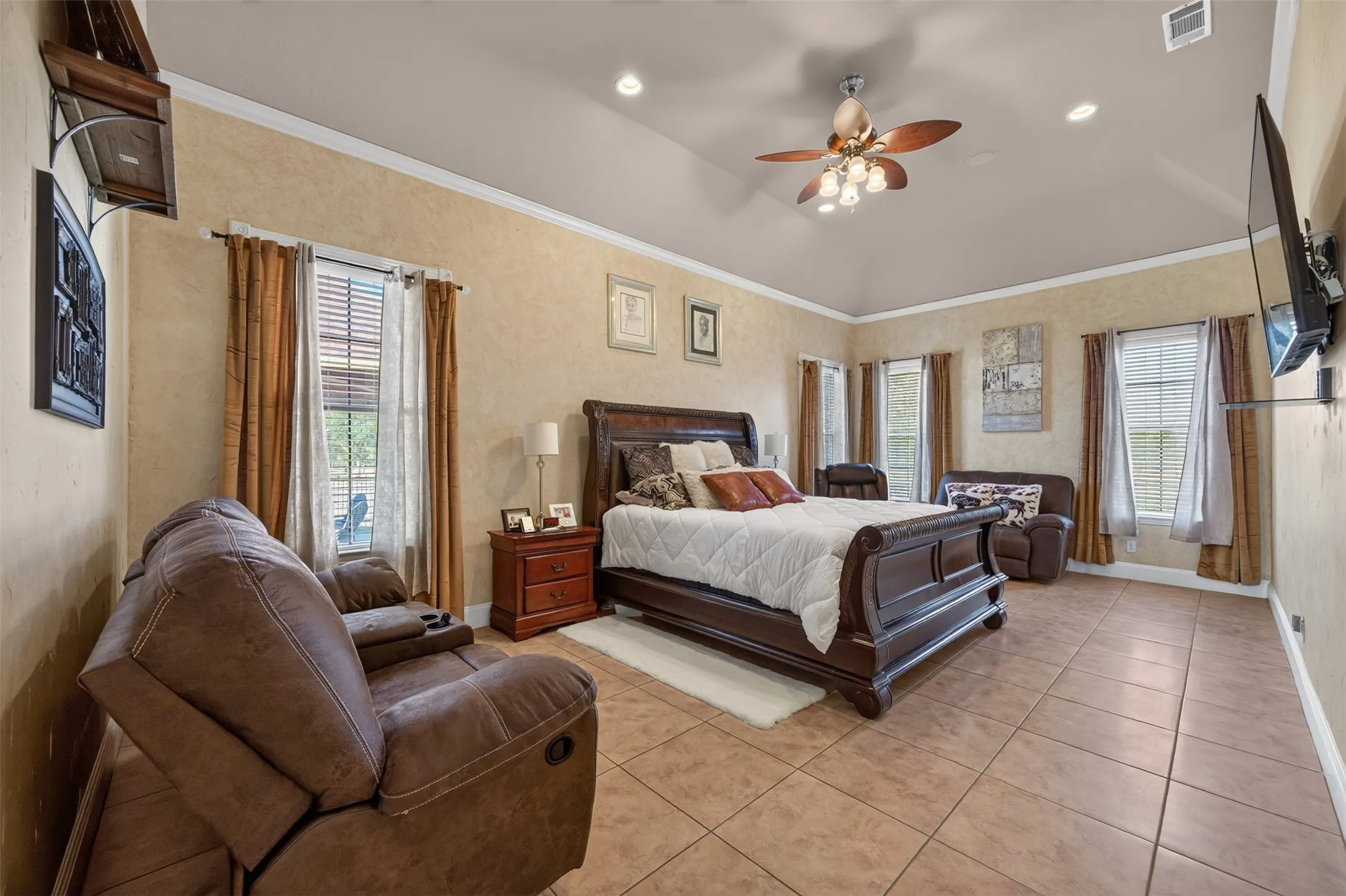 Oversize primary bedroom with soaring windows and sitting area